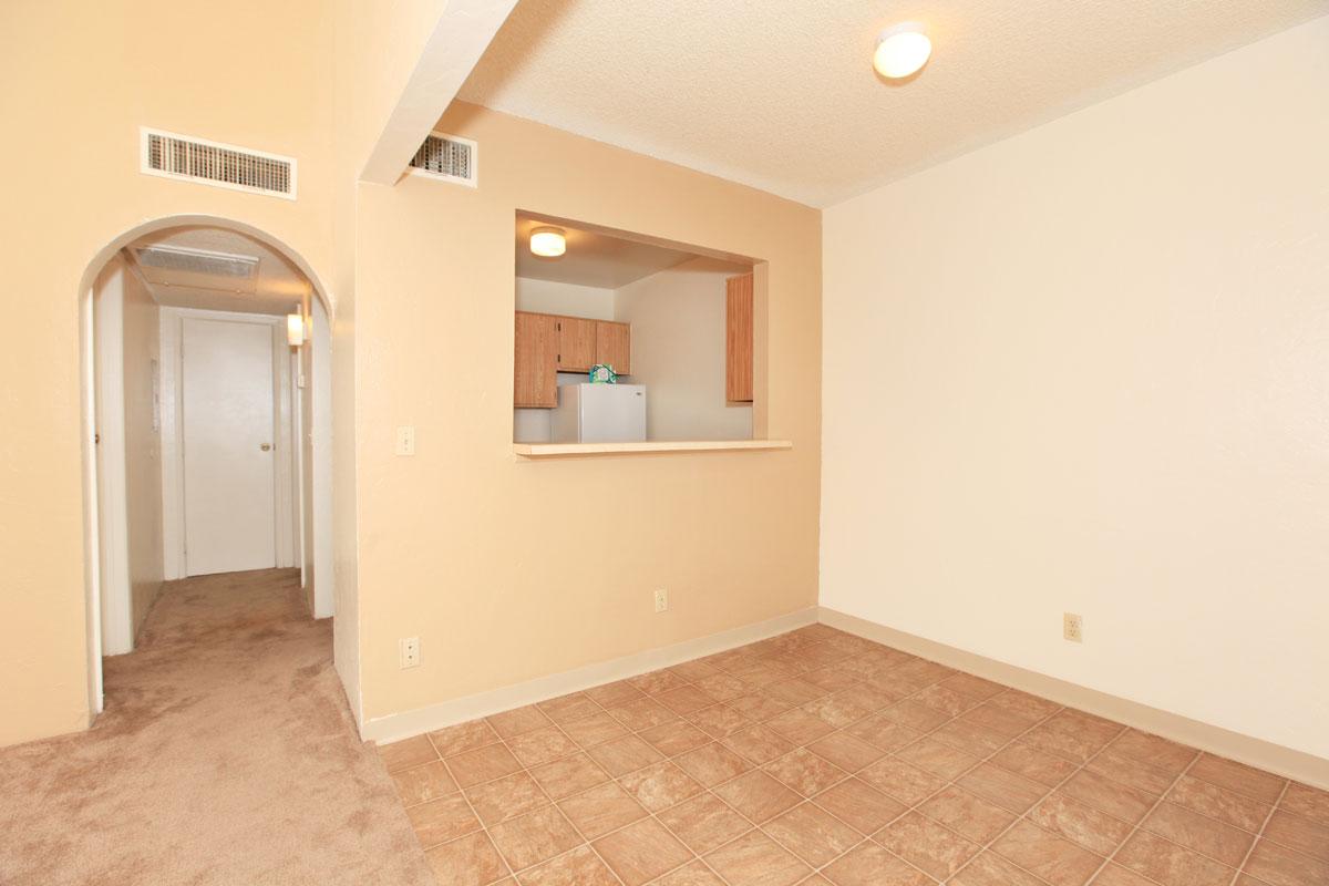 a large empty room with a sink and a mirror