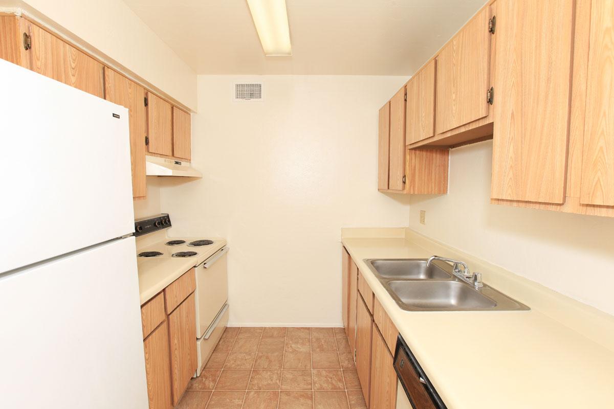 a kitchen with a stove sink and refrigerator