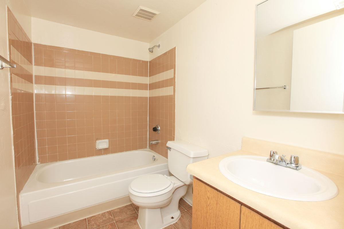 a white tub sitting next to a sink