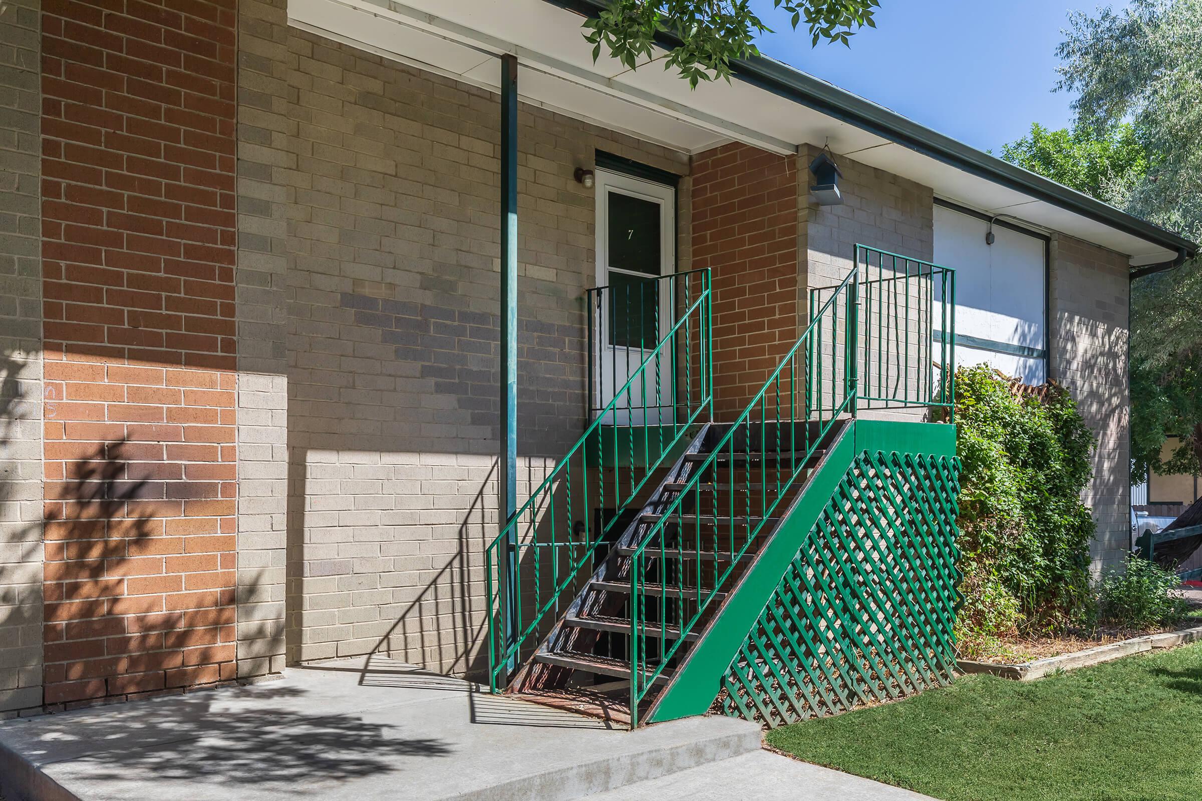 a bench in front of a brick building