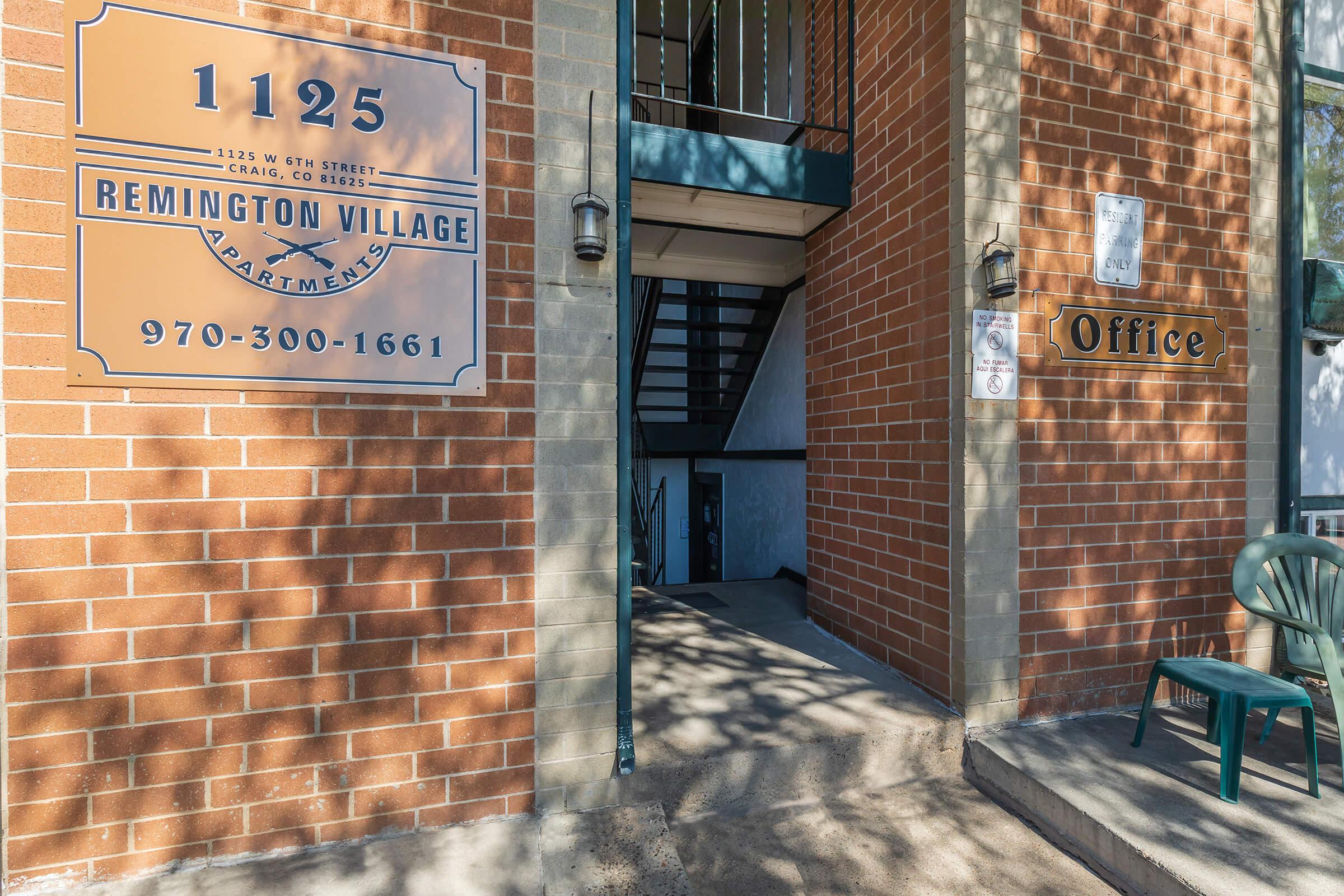 a sign in front of a brick building