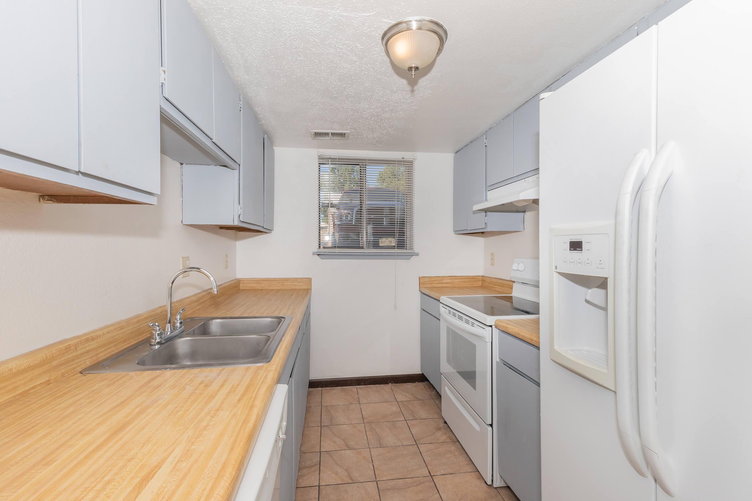 a kitchen with a sink and a refrigerator