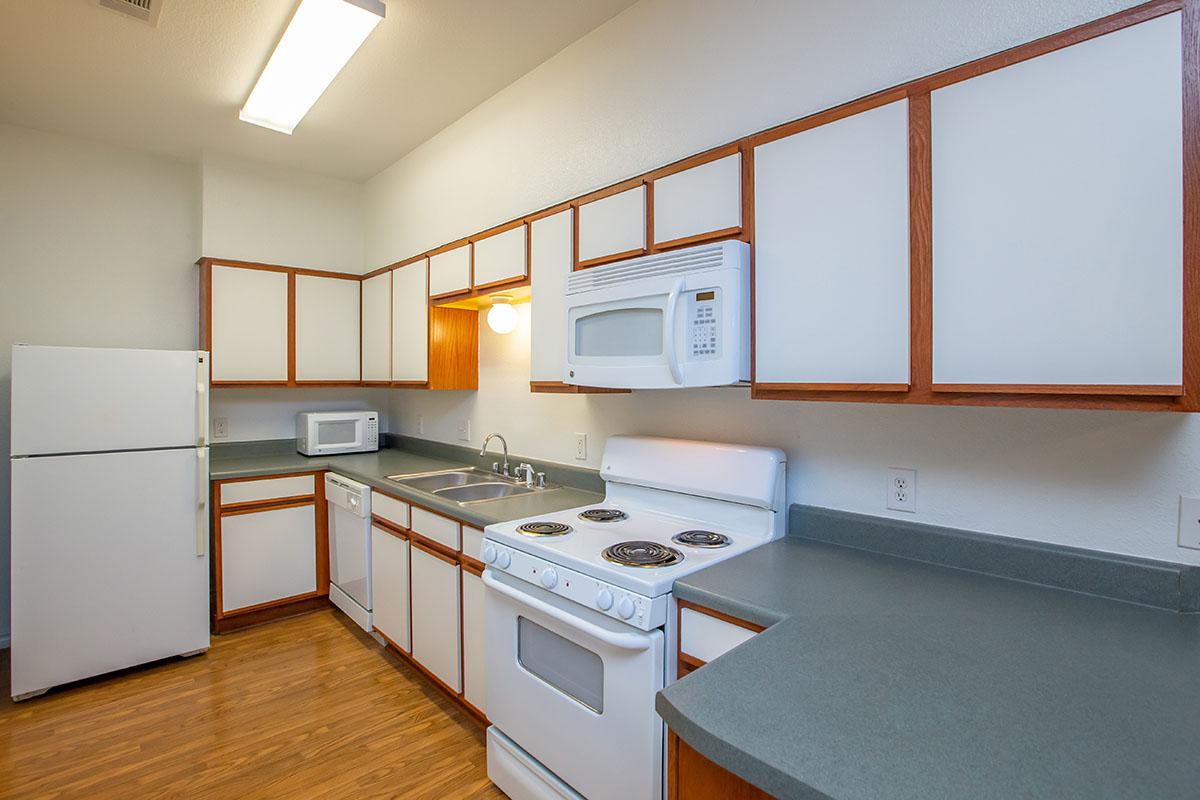 a kitchen with a stove a sink and a microwave