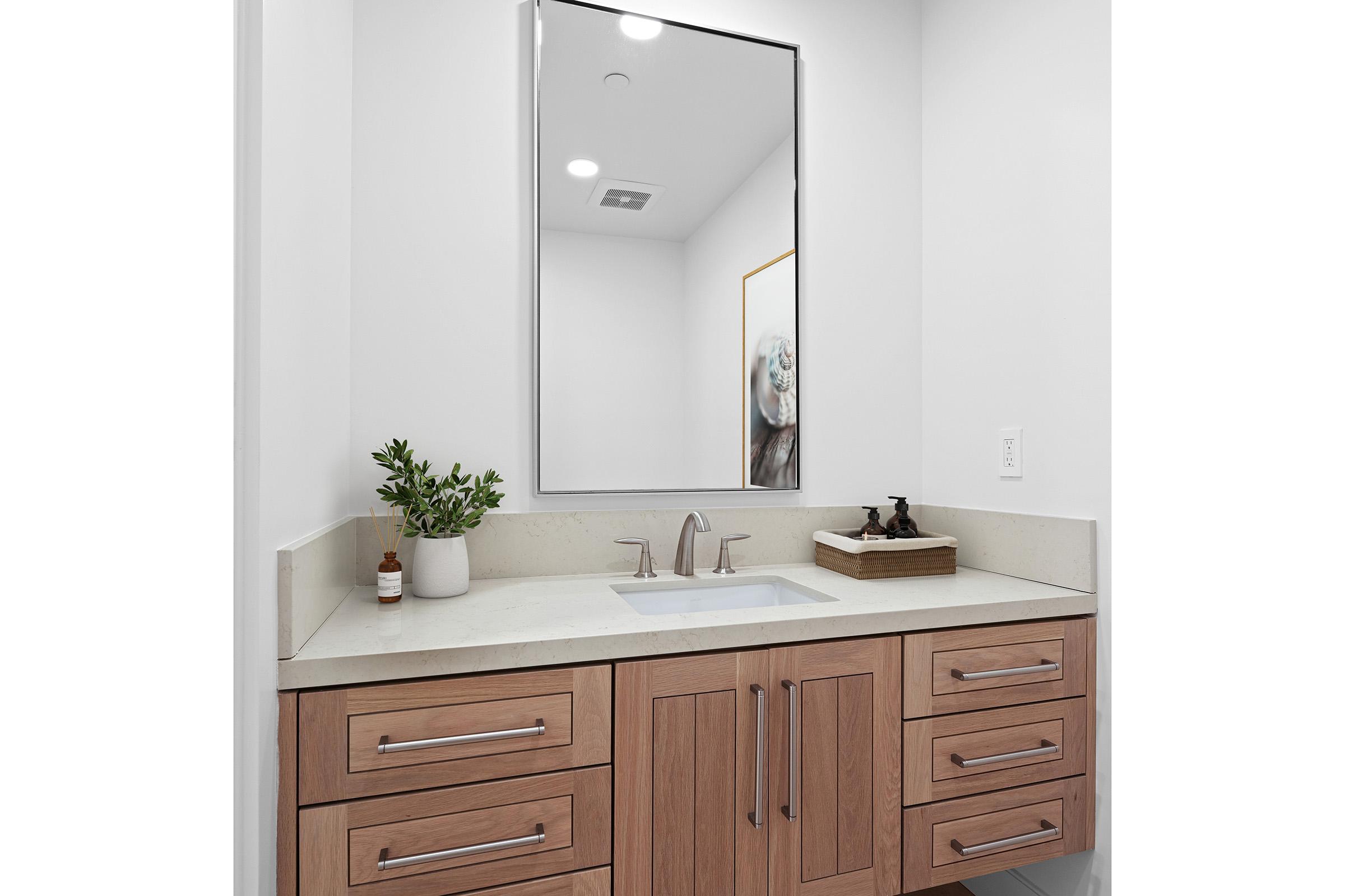 a kitchen with a sink and a mirror