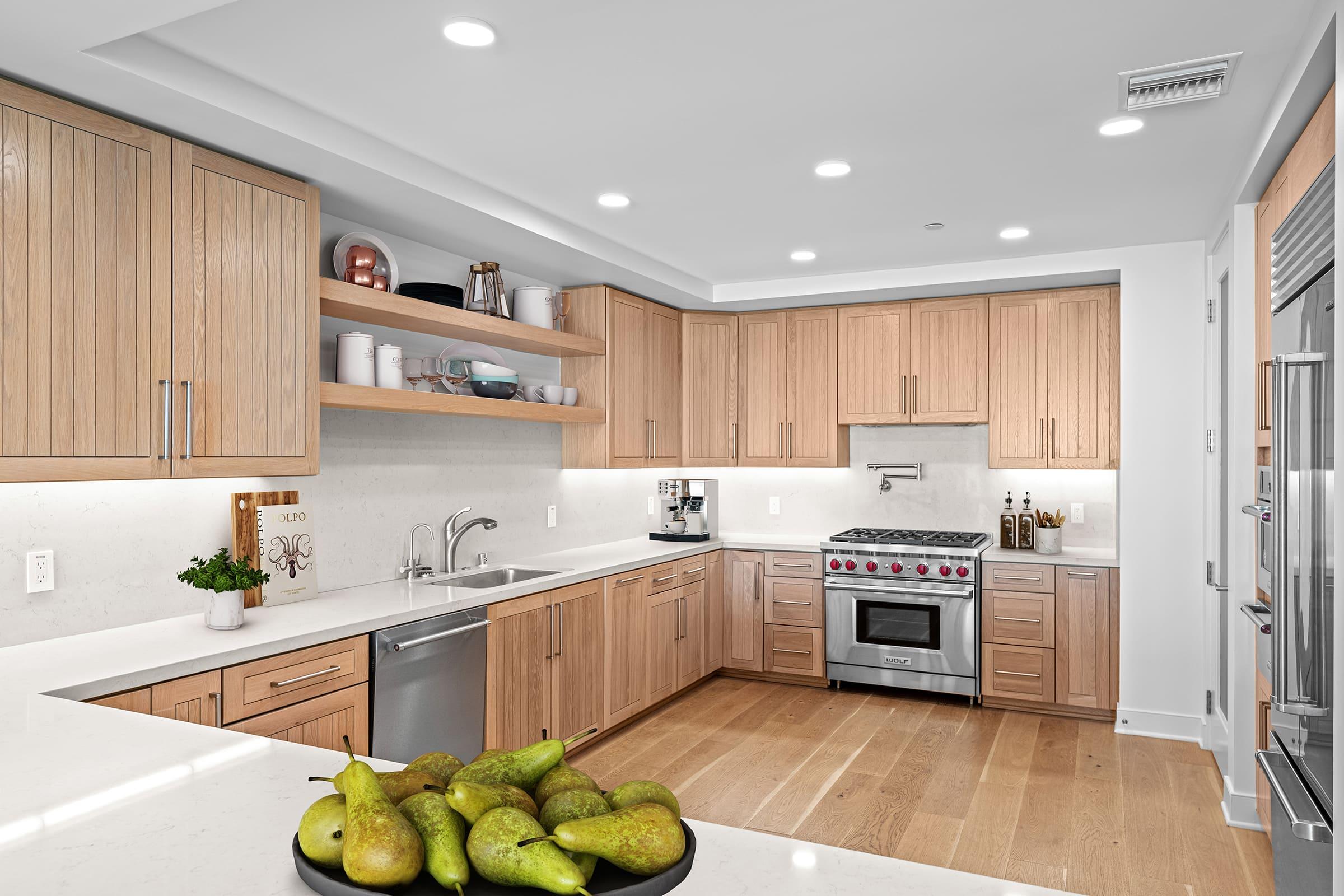 a modern kitchen with stainless steel appliances and wooden cabinets