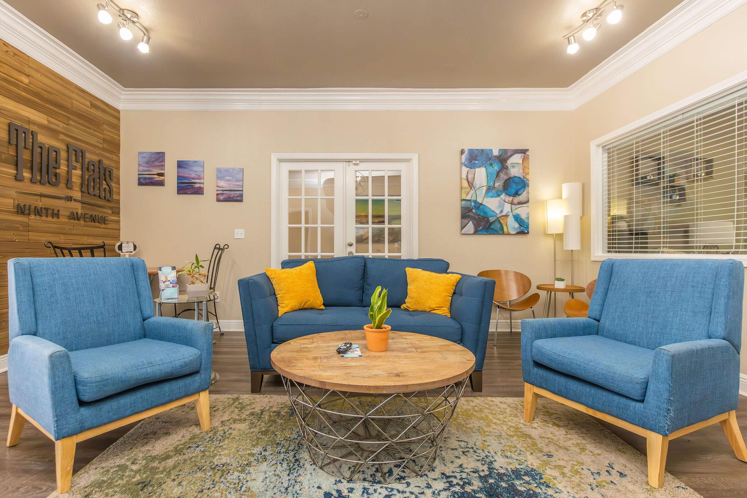 a living room filled with furniture and a blue chair