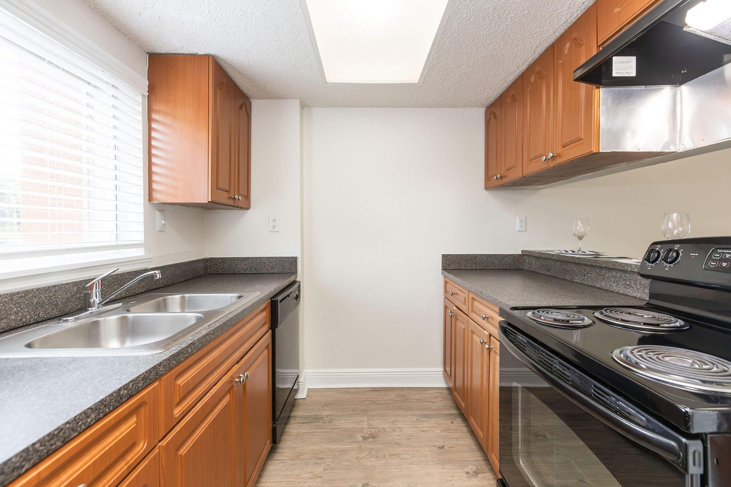 a modern kitchen with stainless steel appliances and wooden cabinets