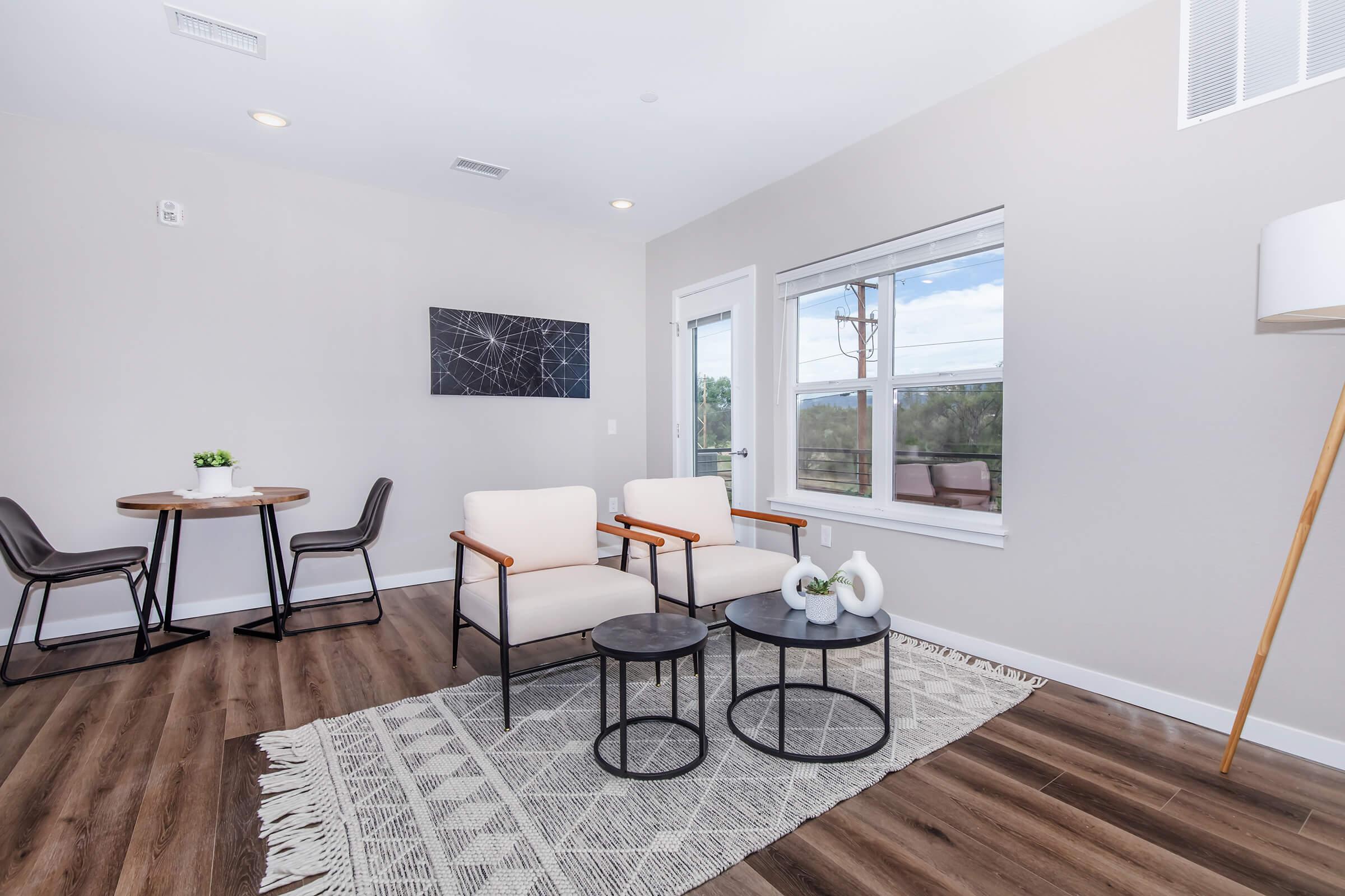 a bedroom with a bed and a chair in a room