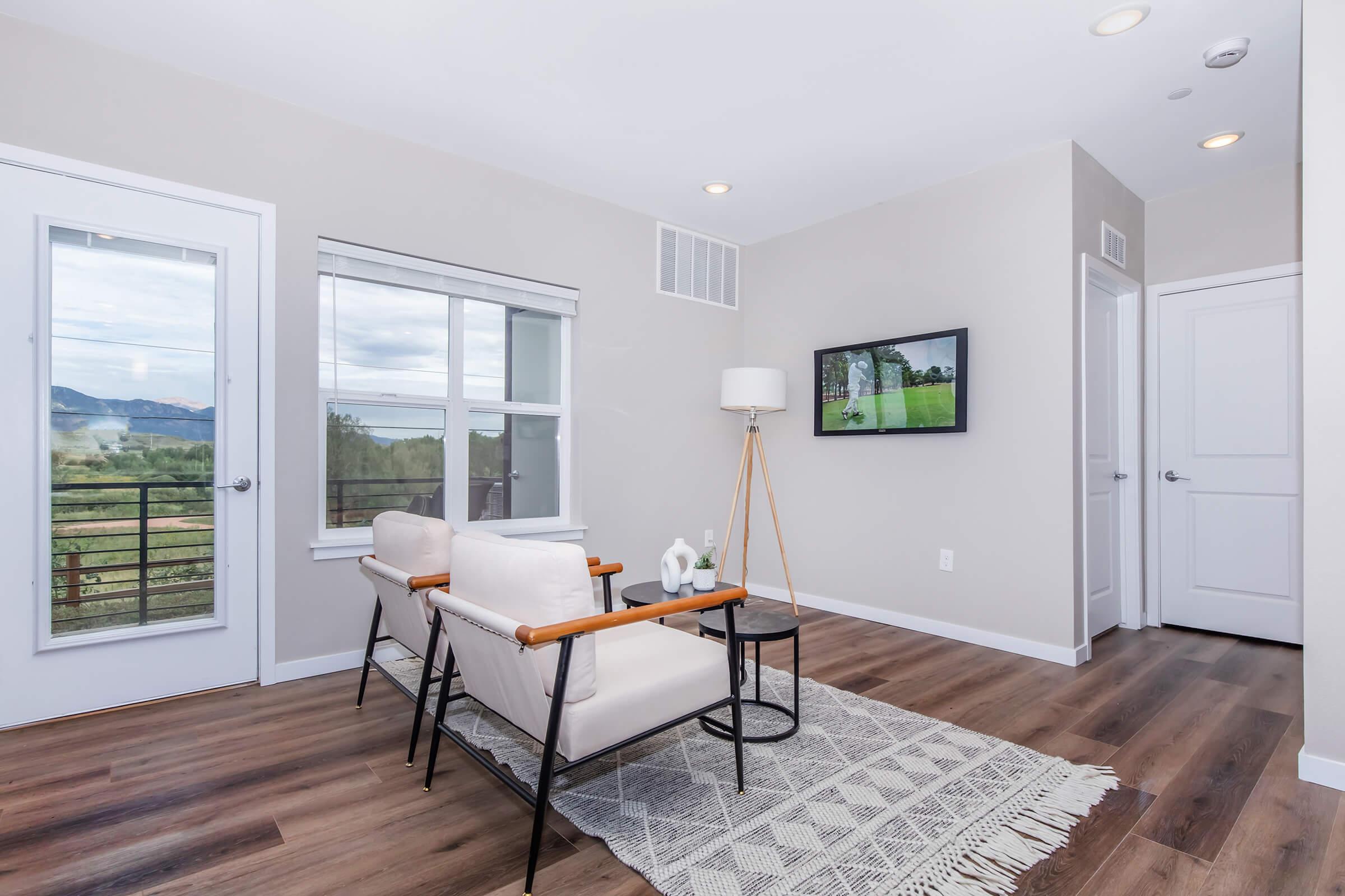 a living room filled with furniture and a large window