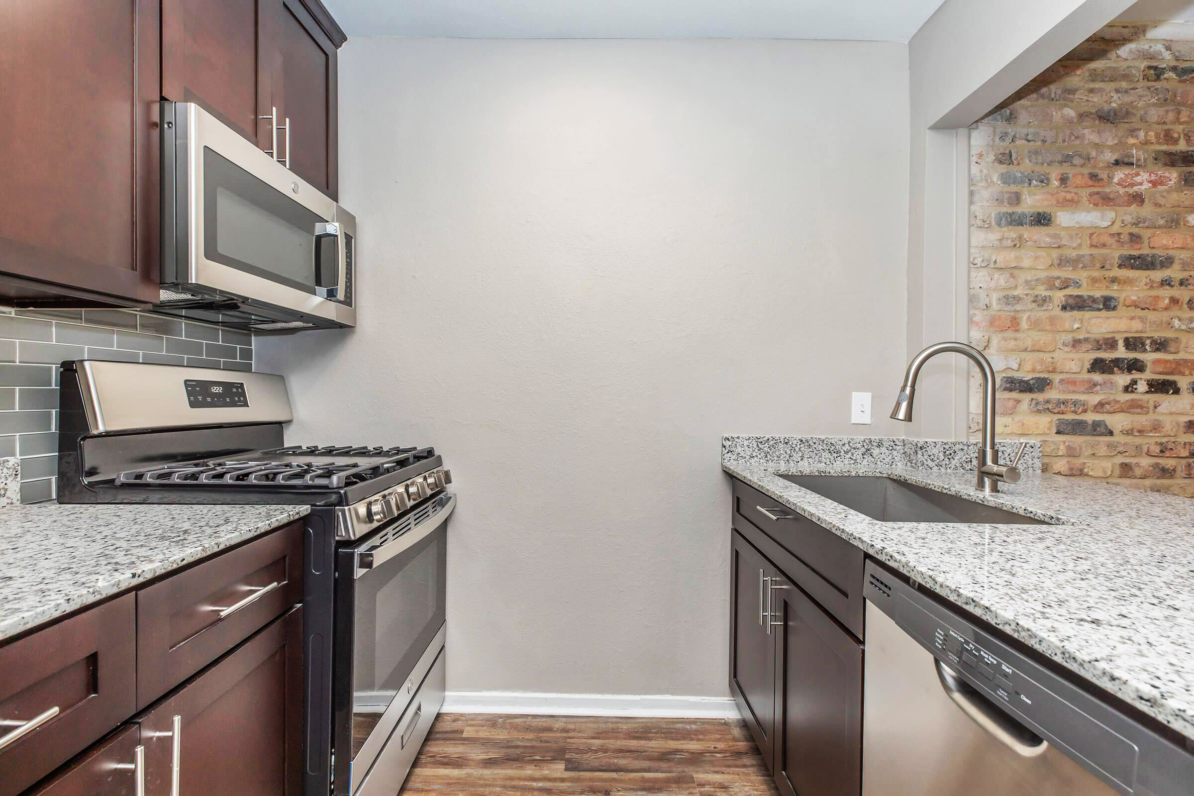 a kitchen with a stove a sink and a microwave