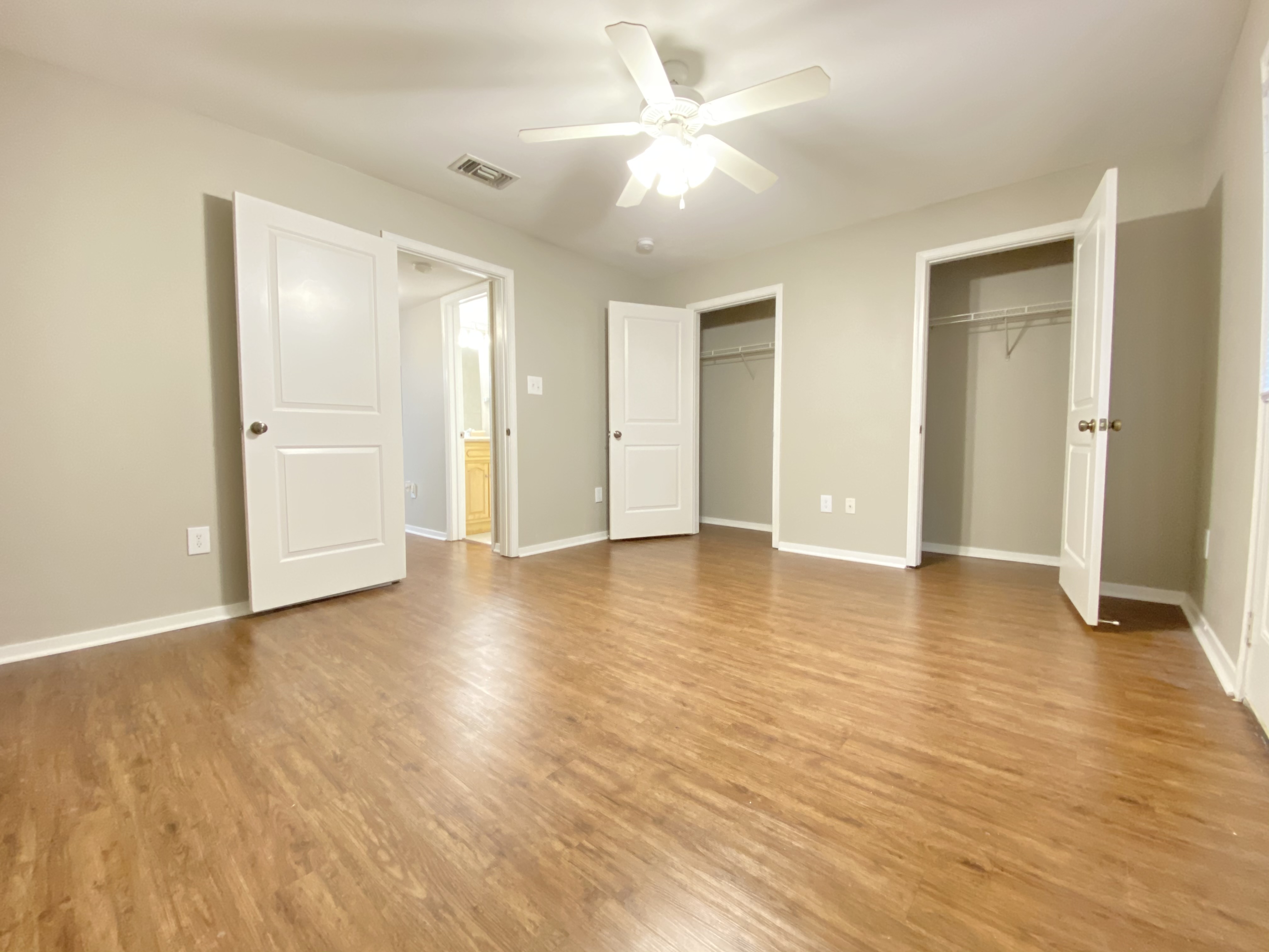 a large empty room with a hard wood floor