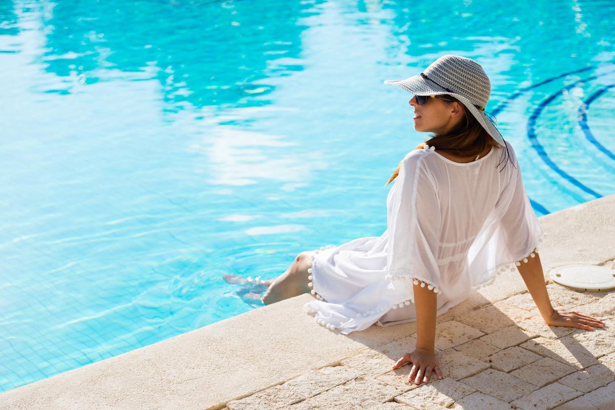 woman relaxing at poolside on summer vacation iStock-516651880.jpg