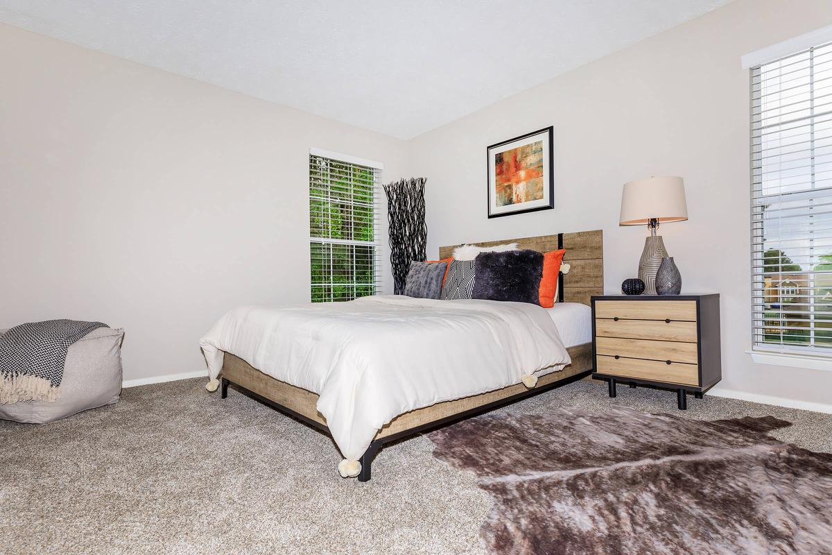 a bedroom with a bed in a room