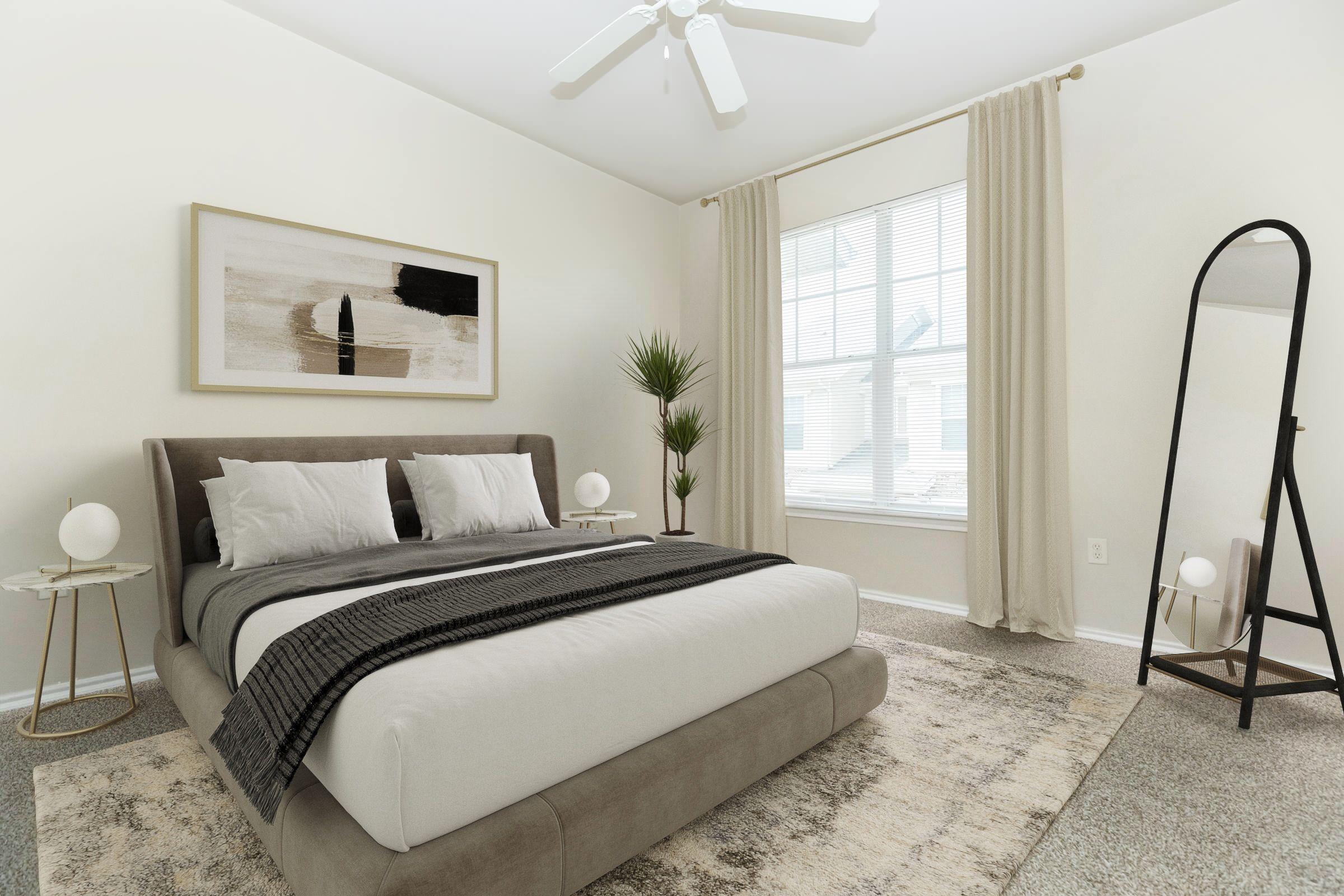 A modern bedroom featuring a plush bed with white linens and decorative pillows, accompanied by bedside tables with lamps. A large mirror stands against the wall, and a potted plant adds a touch of greenery. Natural light streams through a window adorned with curtains, highlighting the neutral color palette.