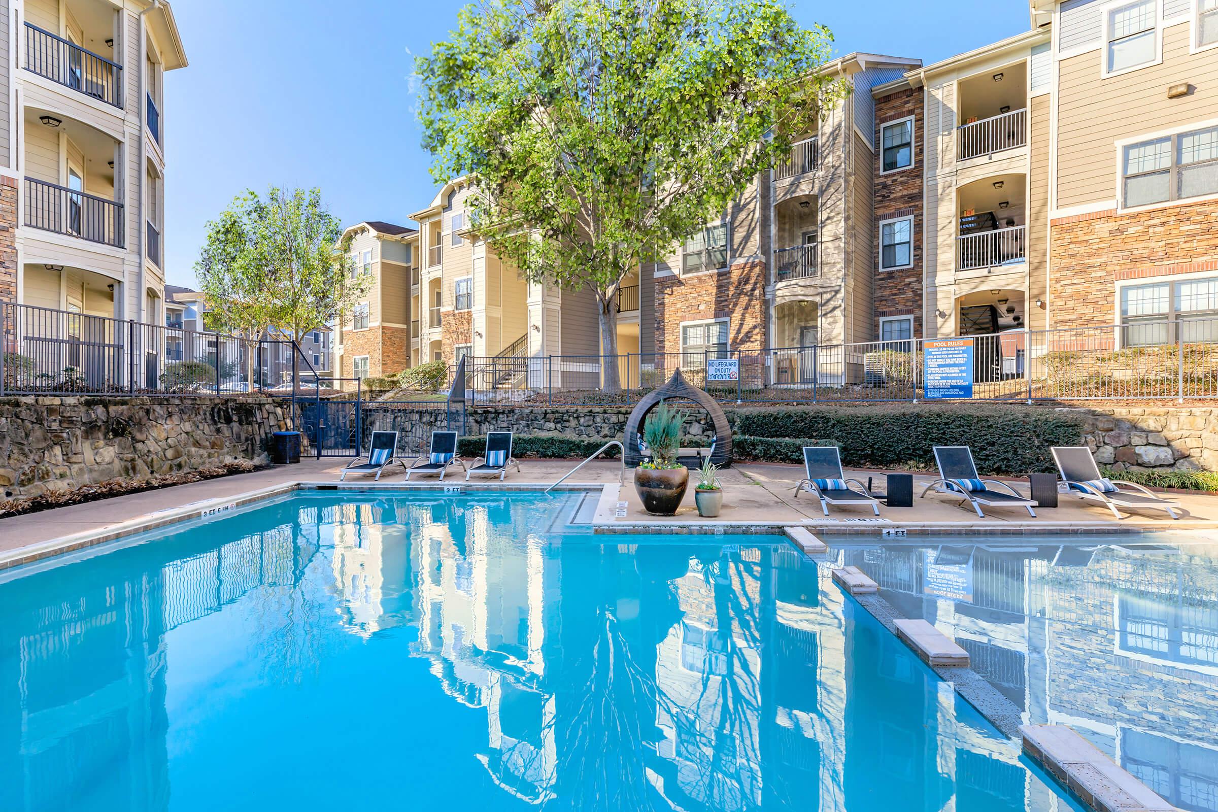 a person in a pool of water in front of a building