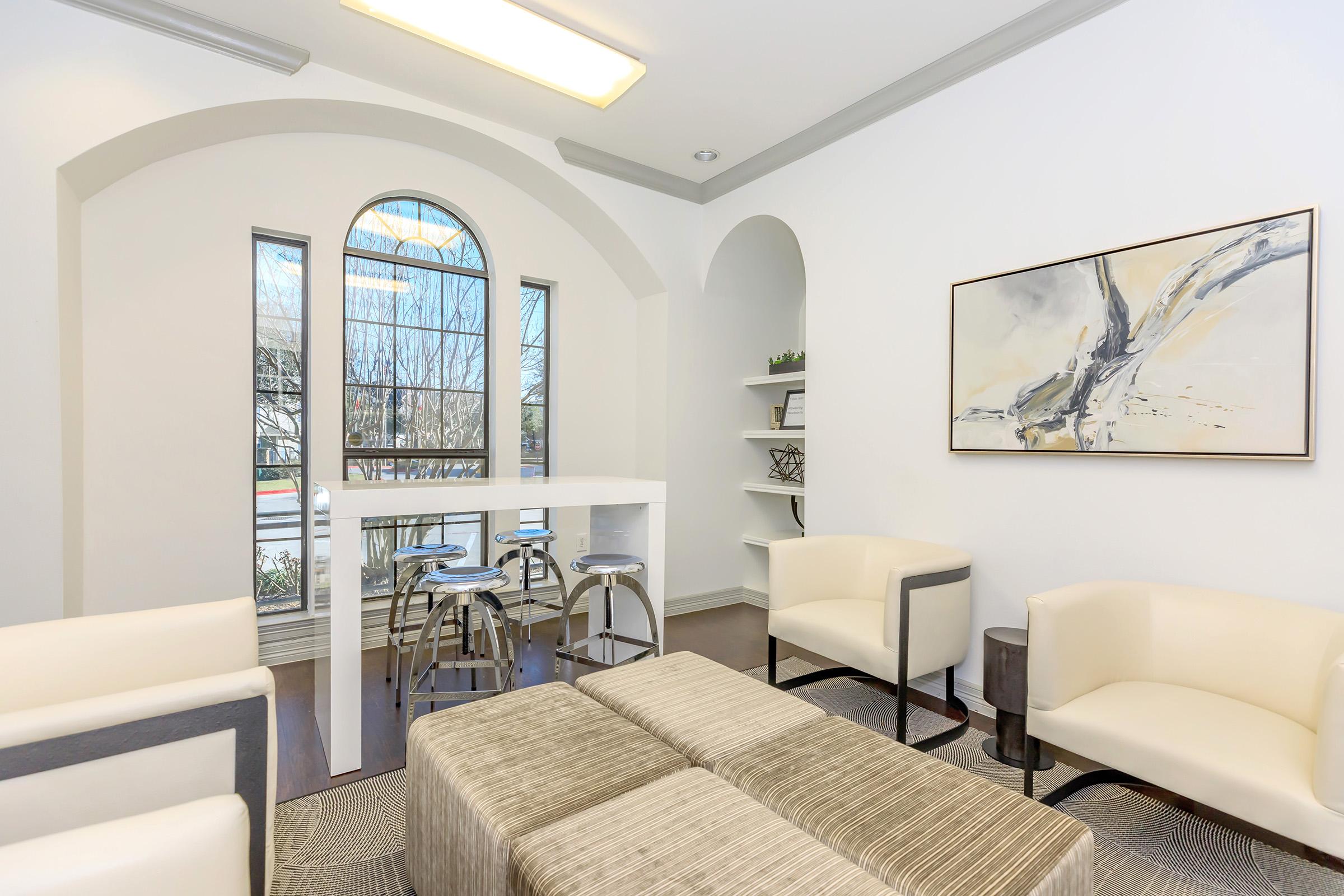 a living room filled with furniture and a large window