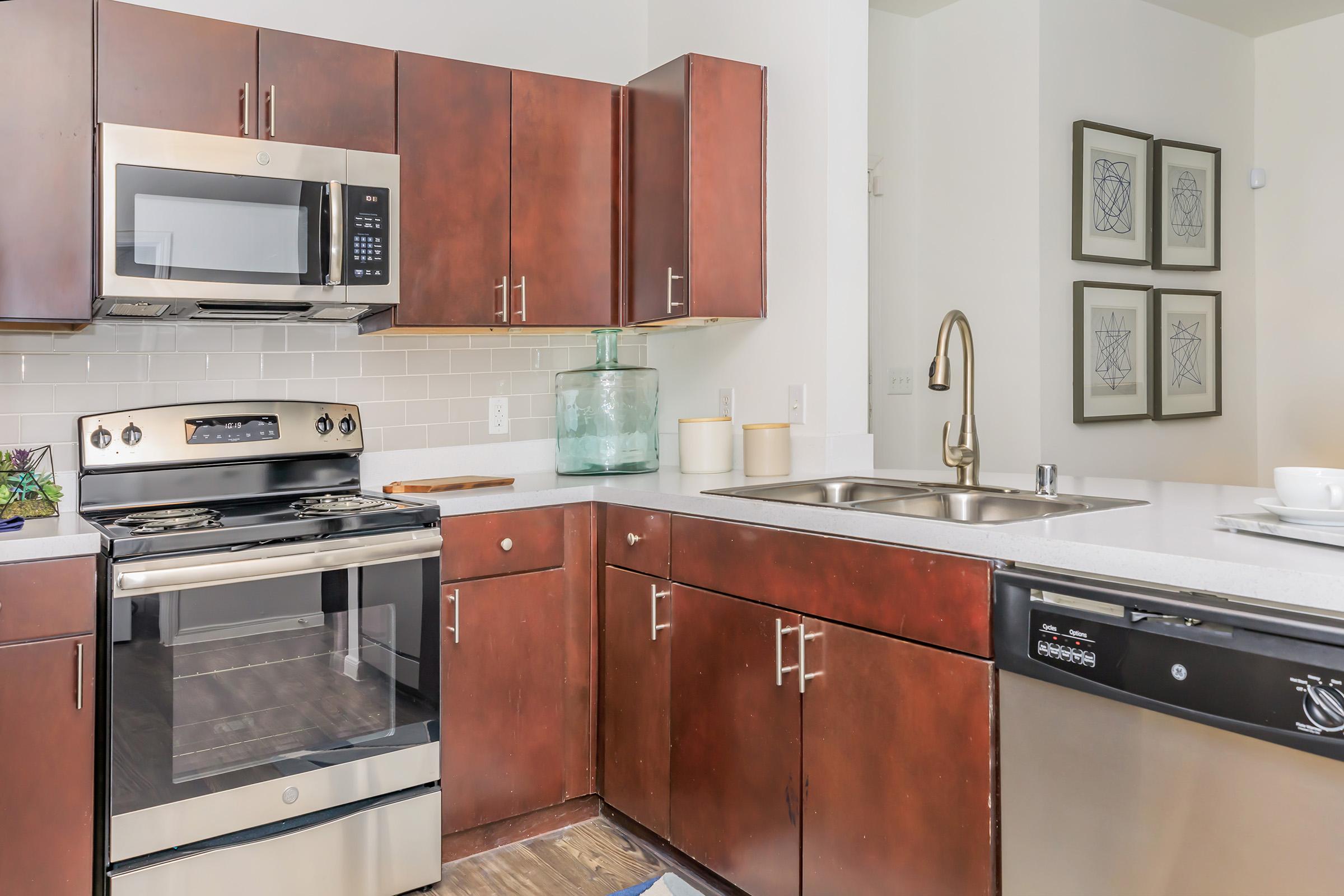 a stove top oven sitting inside of a kitchen