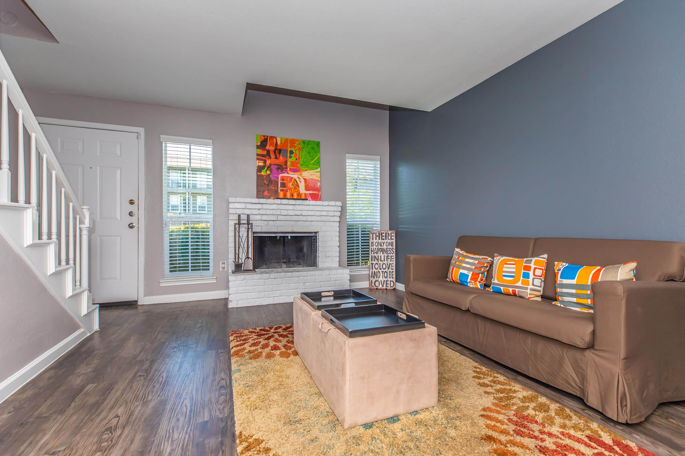 a living room filled with furniture and a flat screen tv