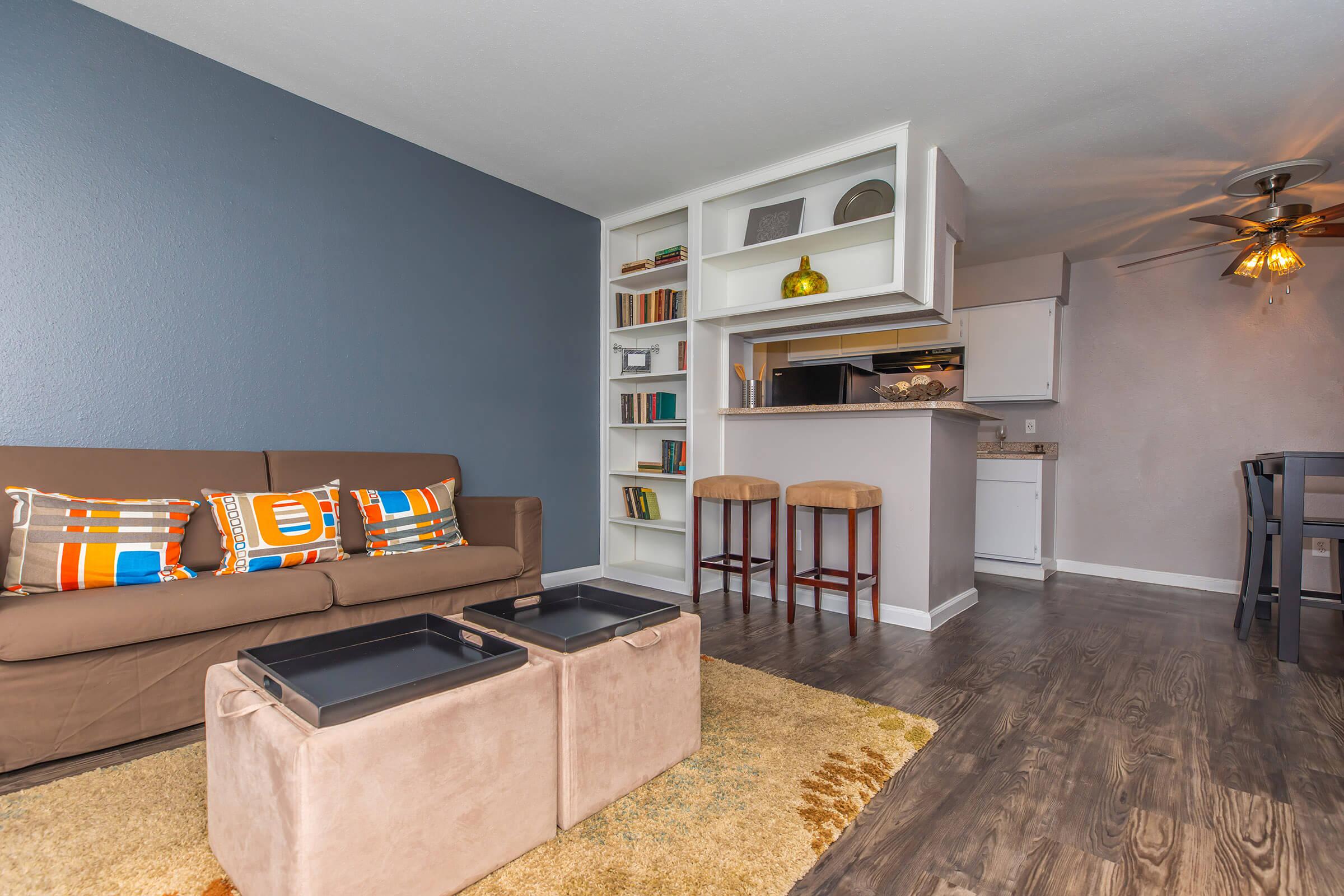 a living room filled with furniture and a flat screen tv