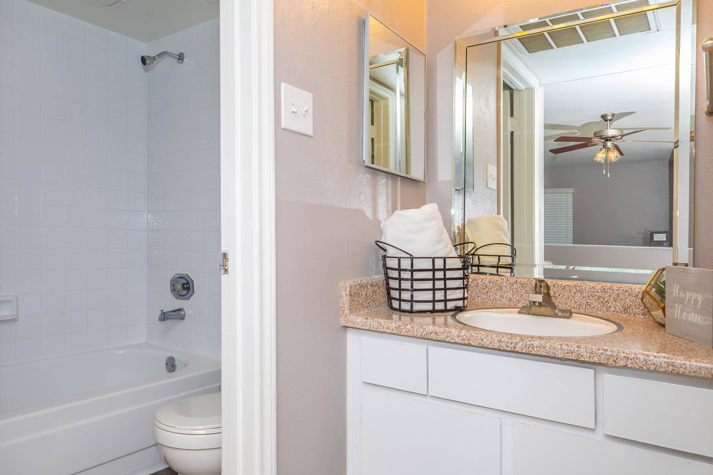 a large white tub next to a sink