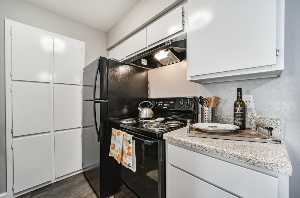 a kitchen with a stove sink and refrigerator