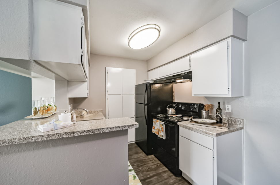 a kitchen with a sink and a mirror