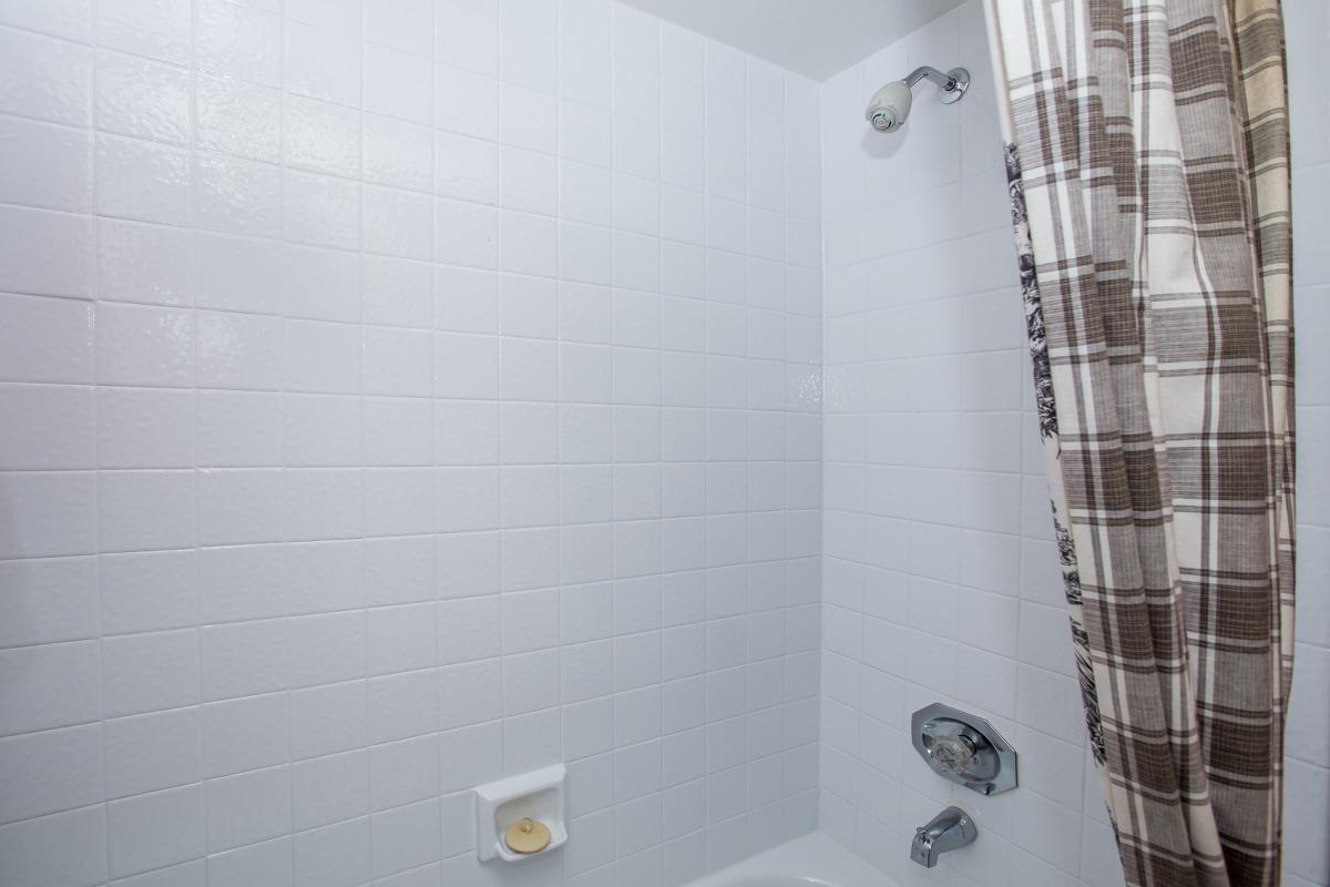 a white tub sitting next to a shower