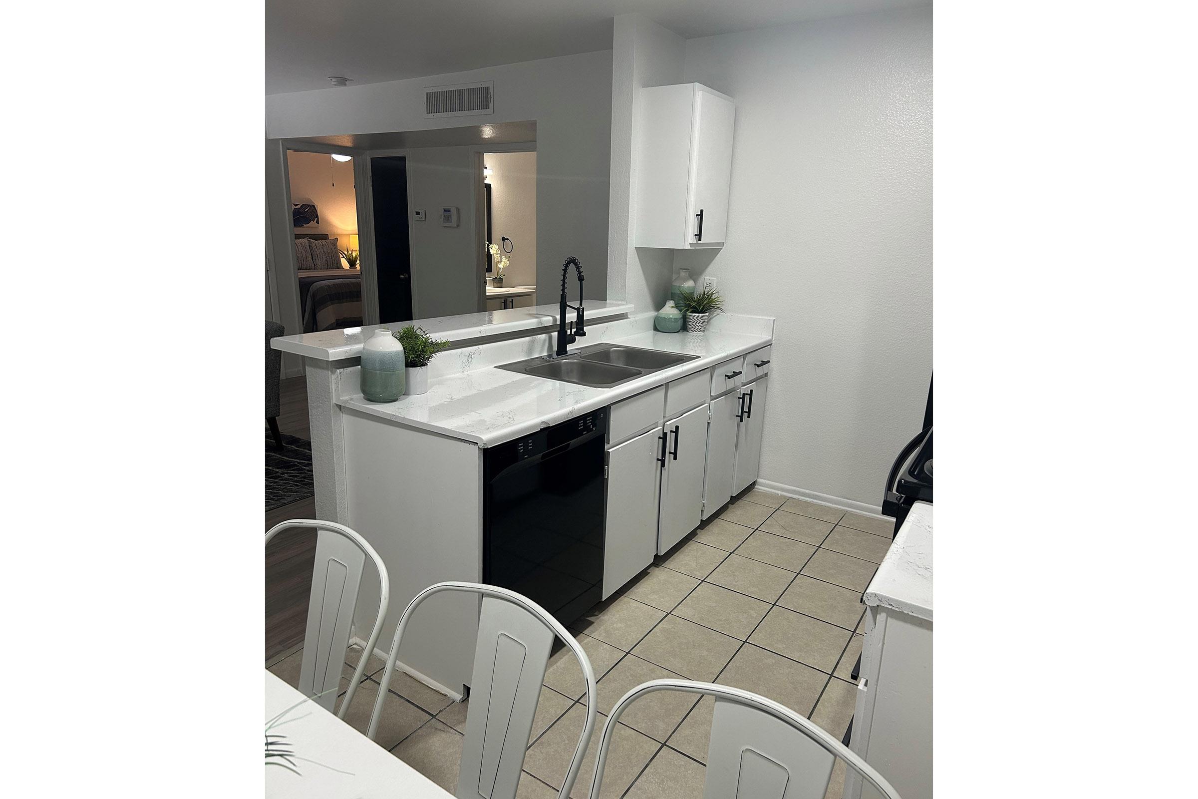 a kitchen with a sink and a mirror