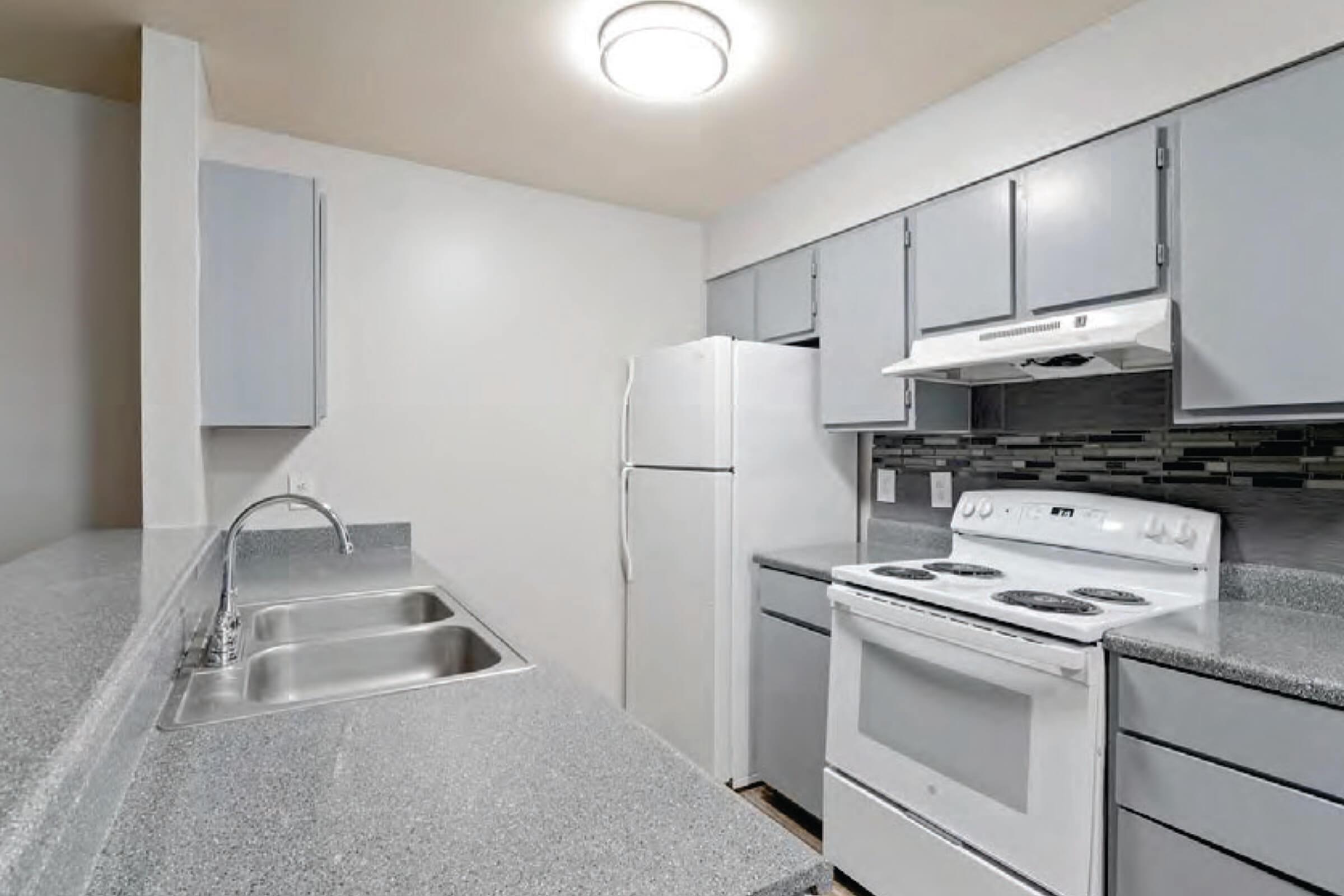 a stove top oven sitting inside of a kitchen