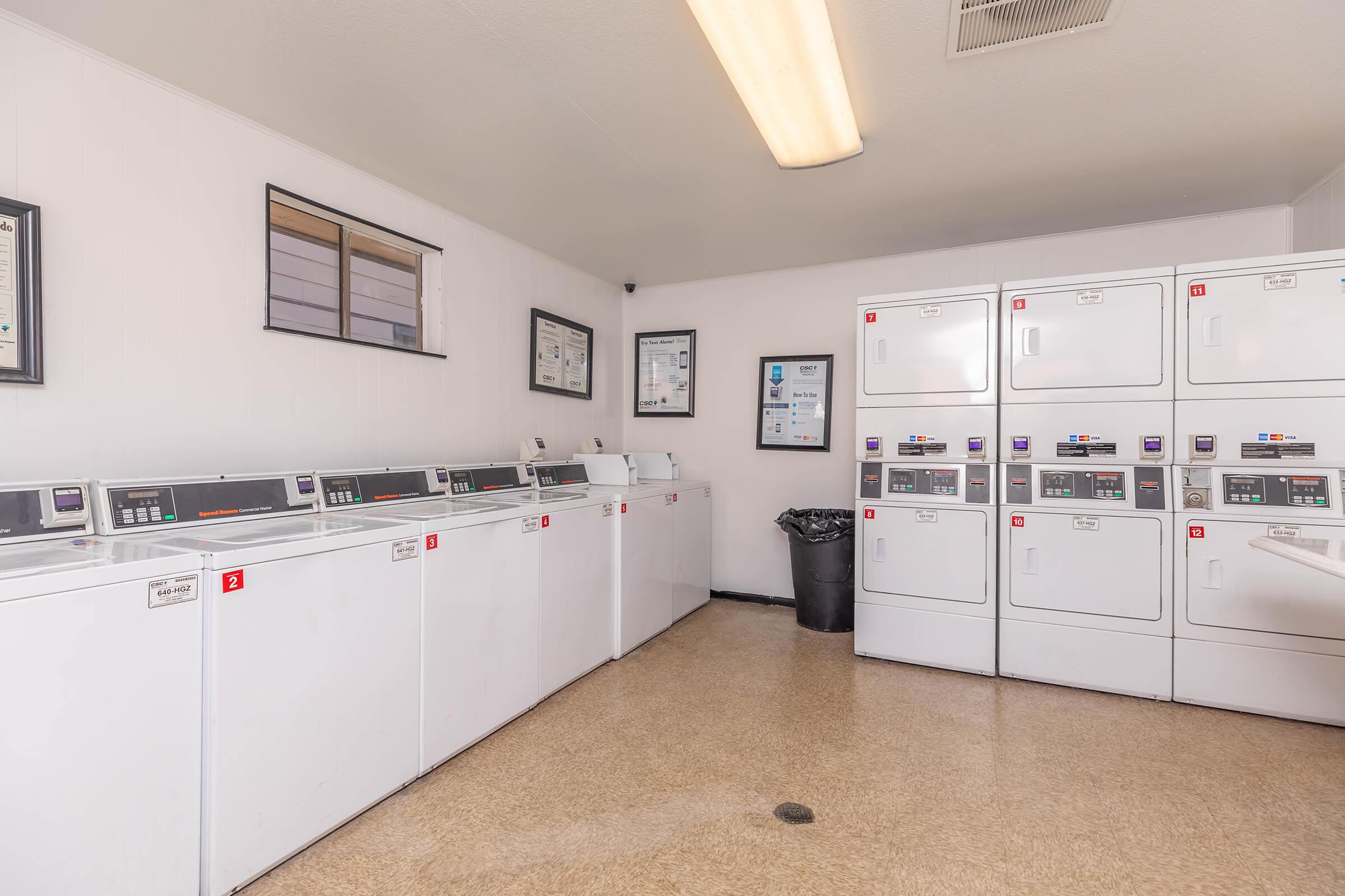 a kitchen with a white refrigerator freezer sitting in a room