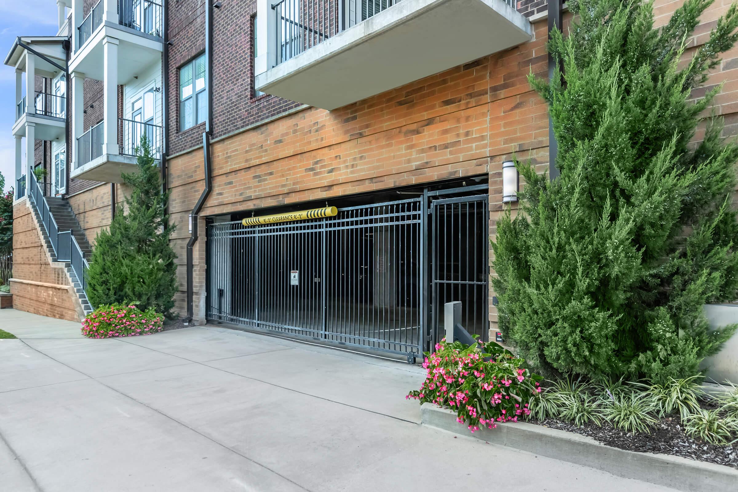 a house with bushes in front of a brick building