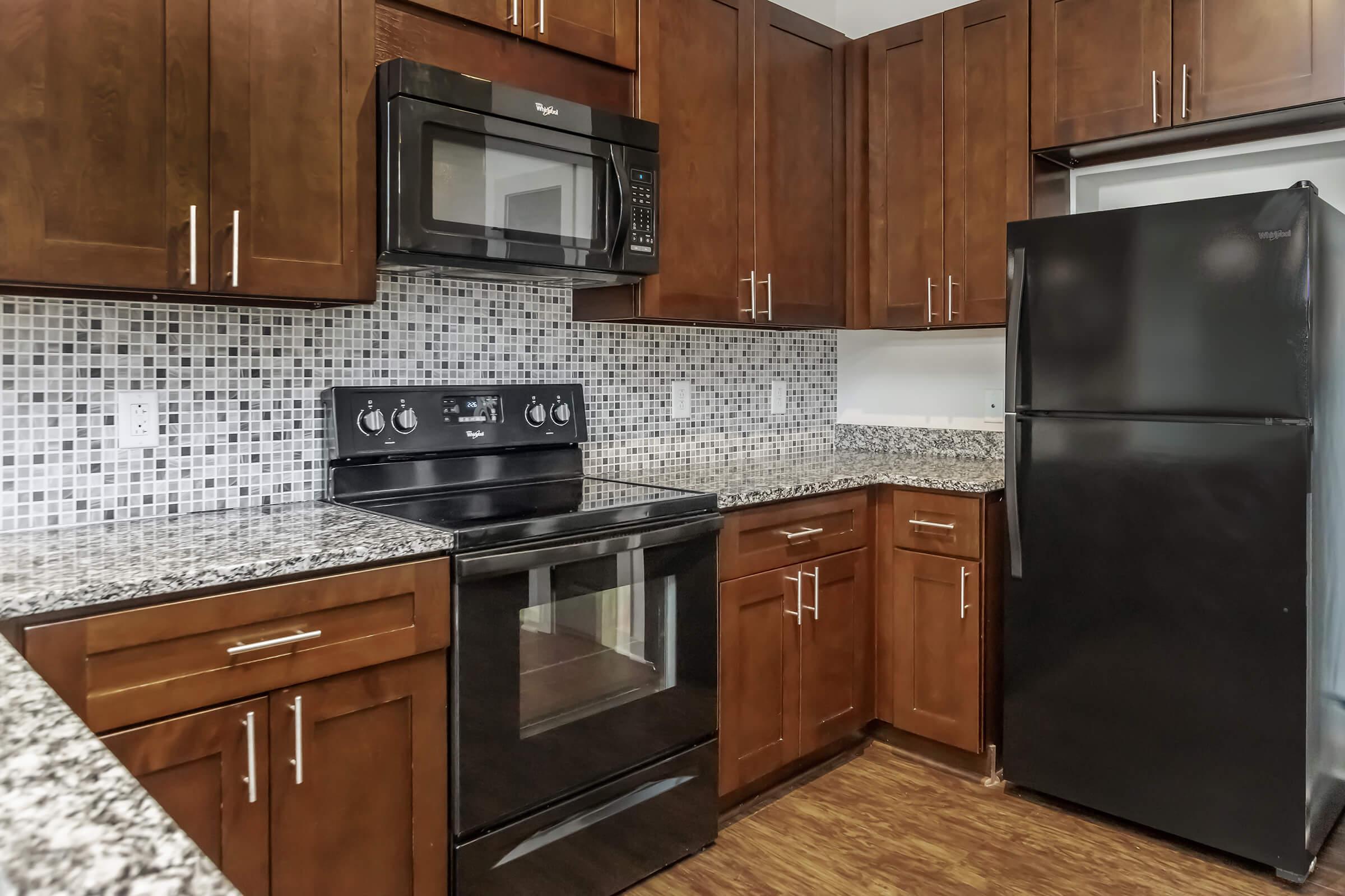 a kitchen with stainless steel appliances and wooden cabinets