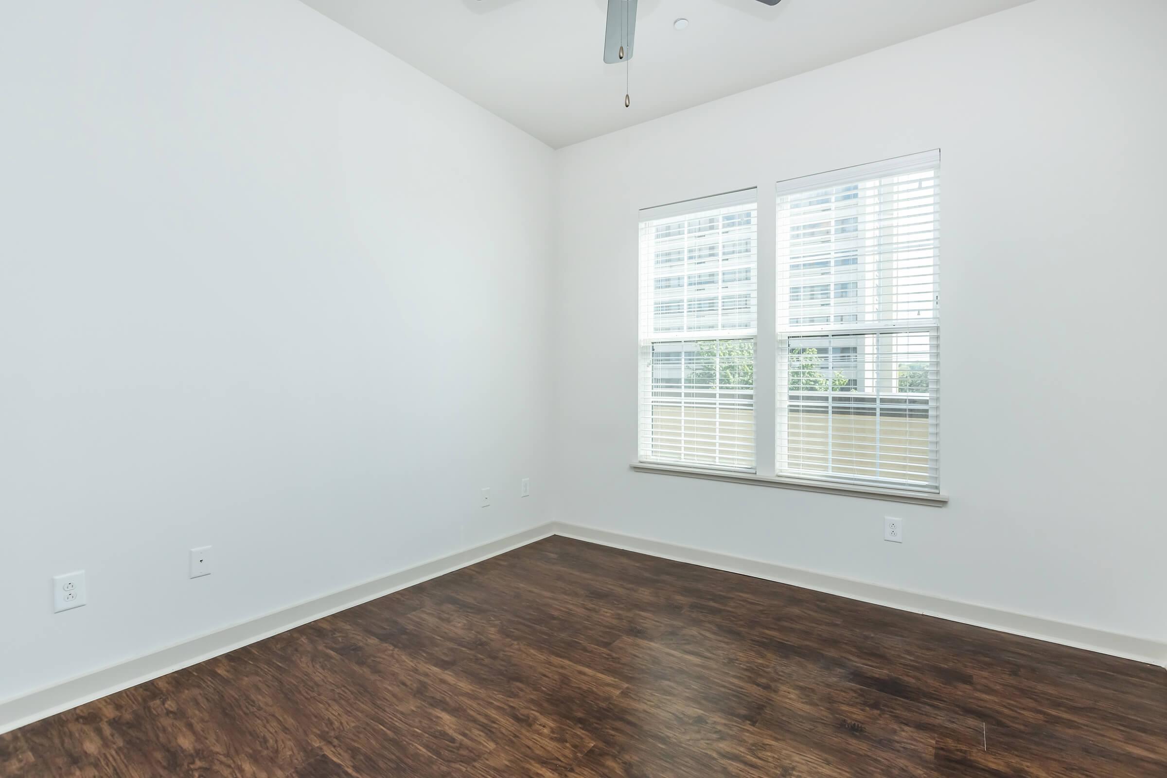 Bedroom 2 hardwood flooring and window