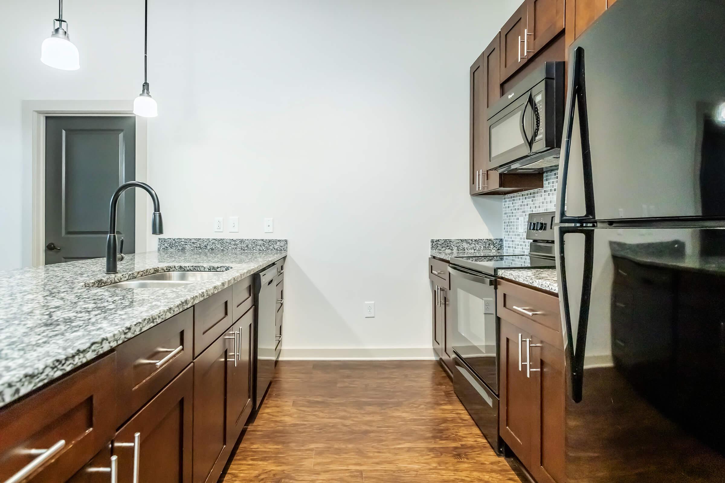 a kitchen with stainless steel appliances and wooden cabinets