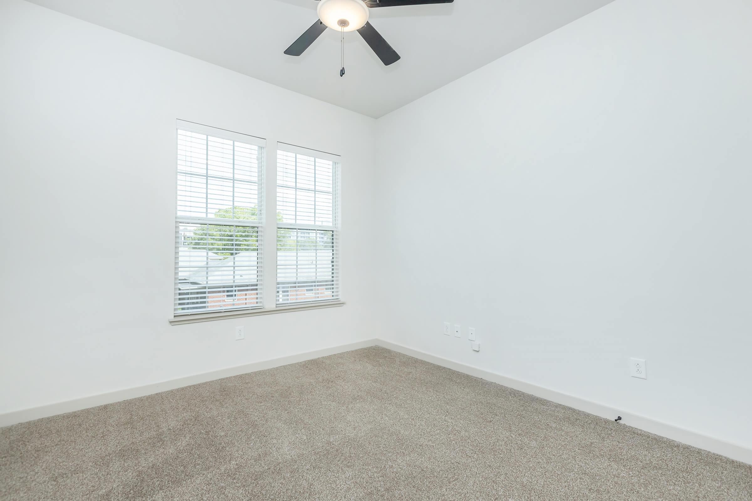 a bedroom with a large window