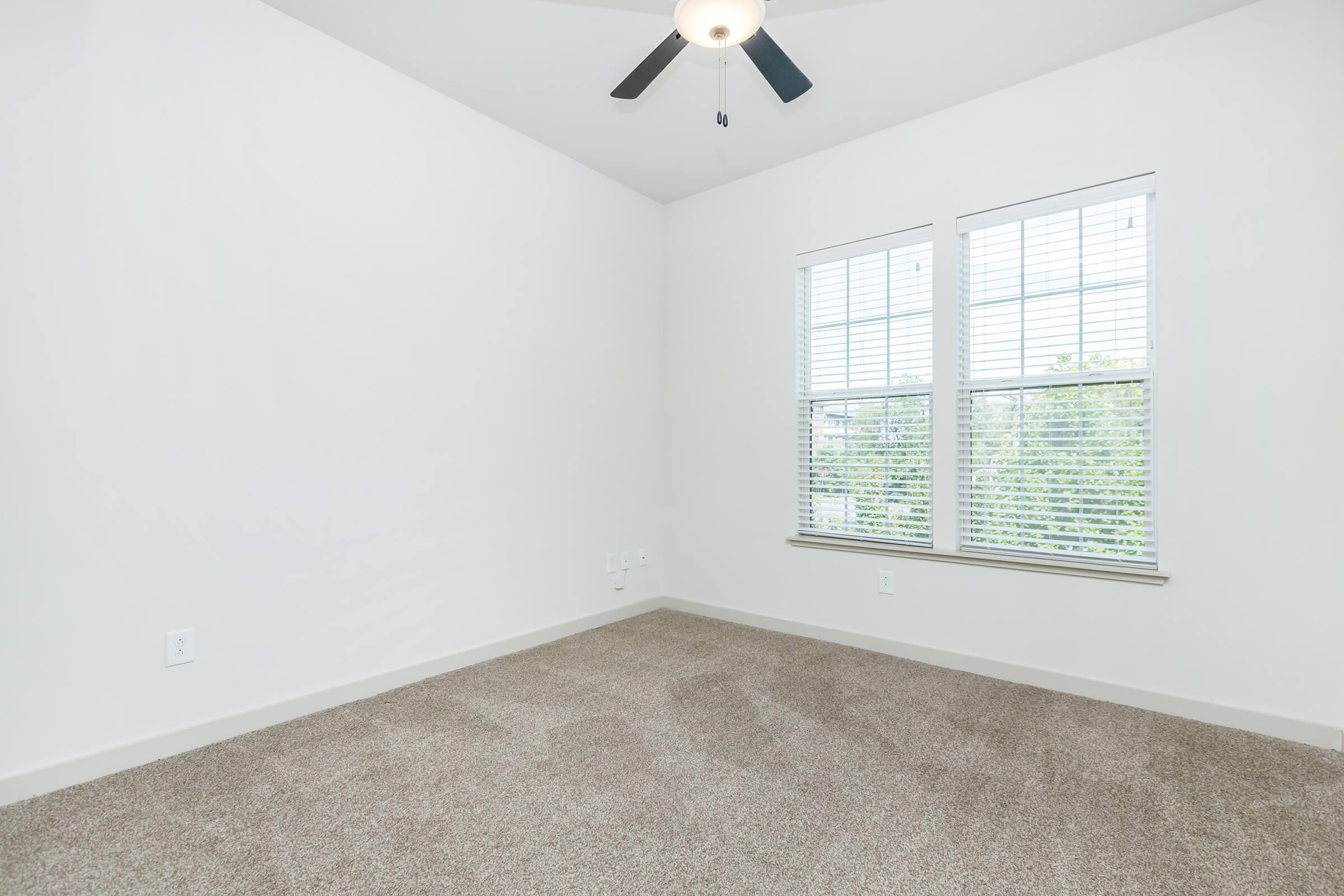 Bedroom 2 with ceiling fan and window