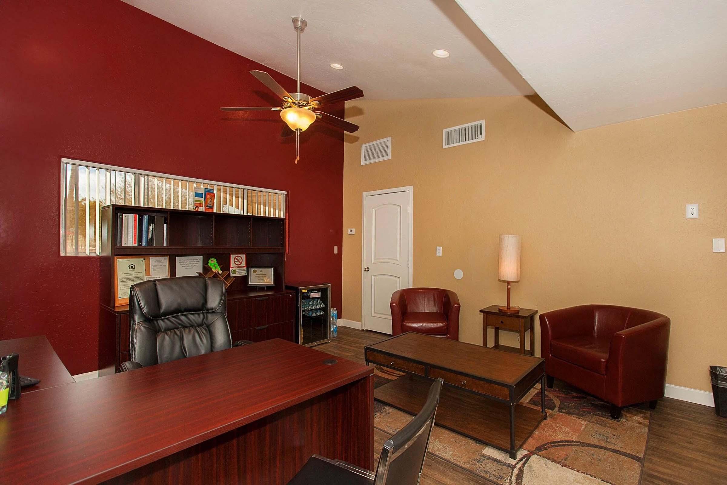 a bedroom with a bed and desk in a small room