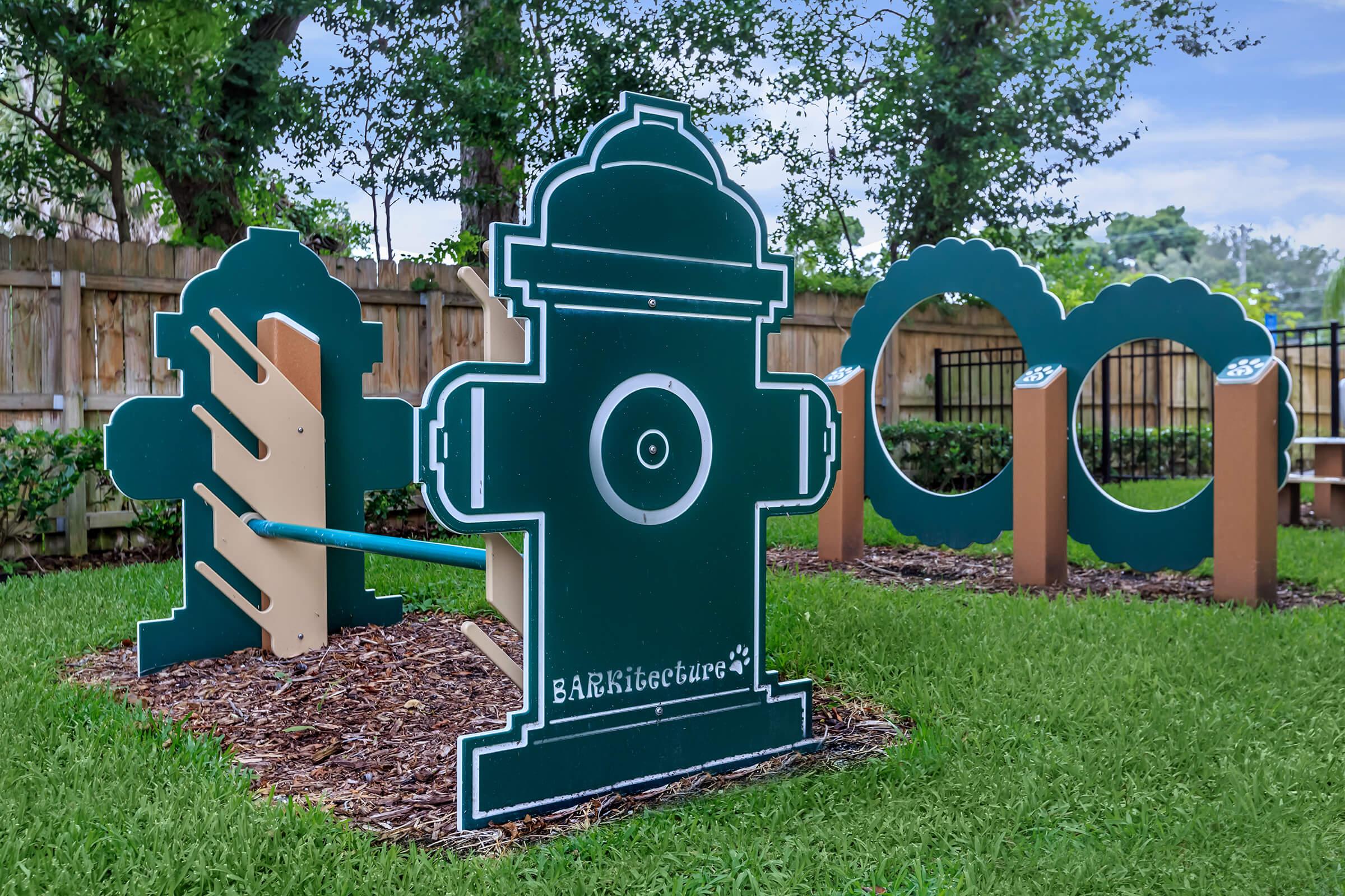 a green lawn in front of a sign