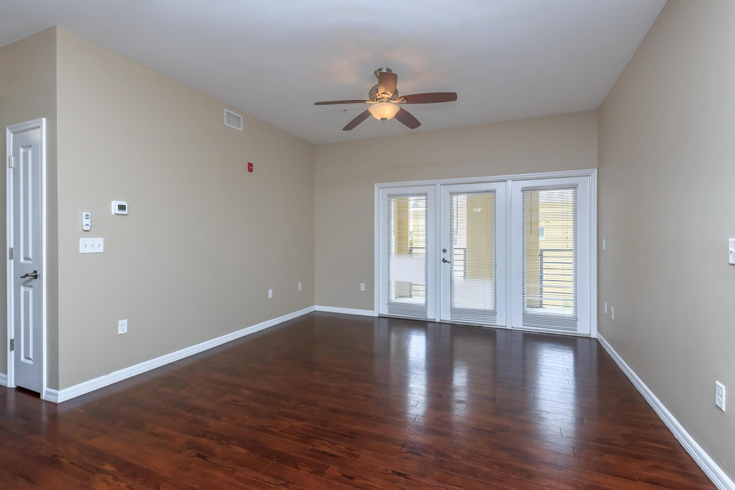 a large empty room with a wood floor