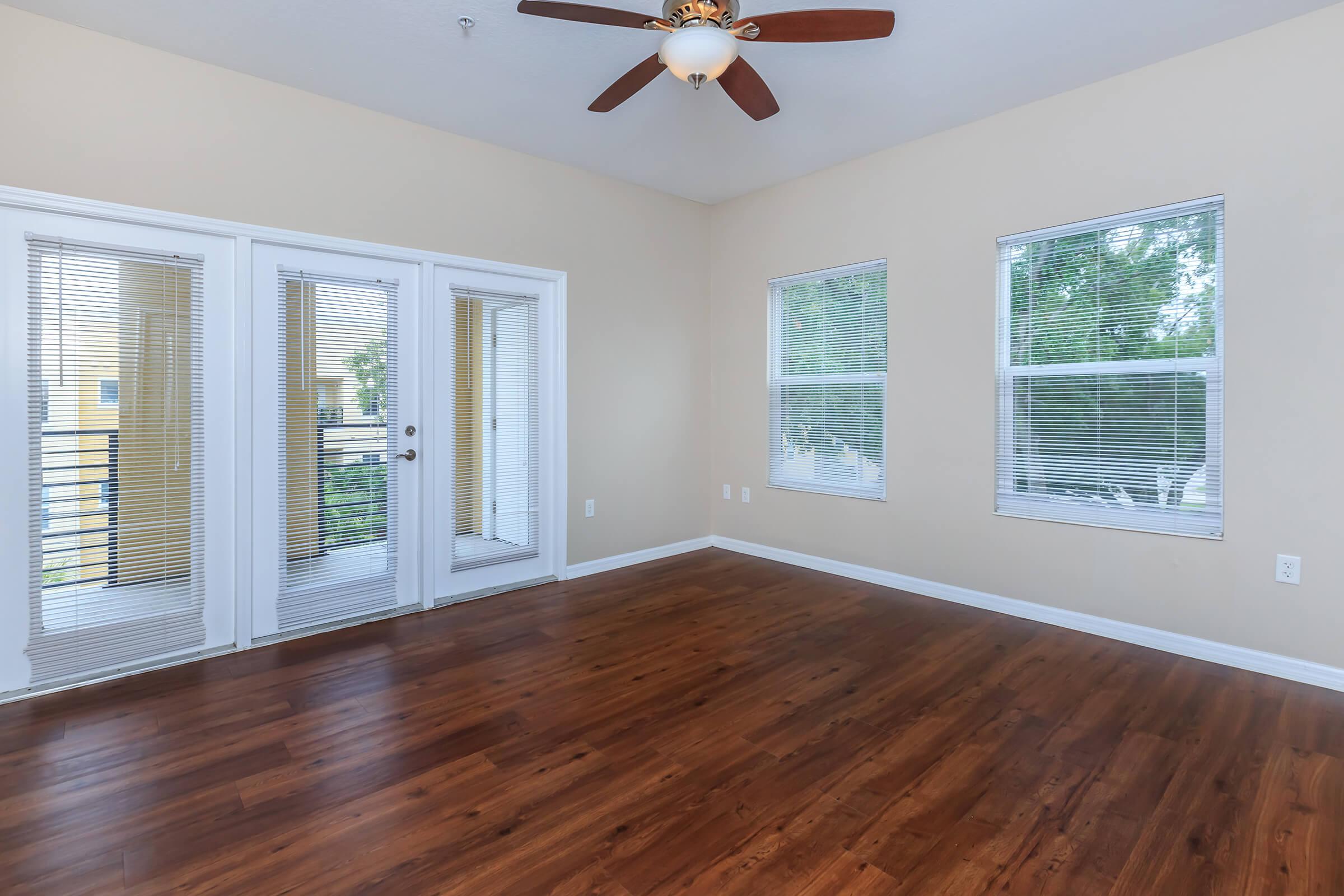 a close up of a hard wood floor next to a window