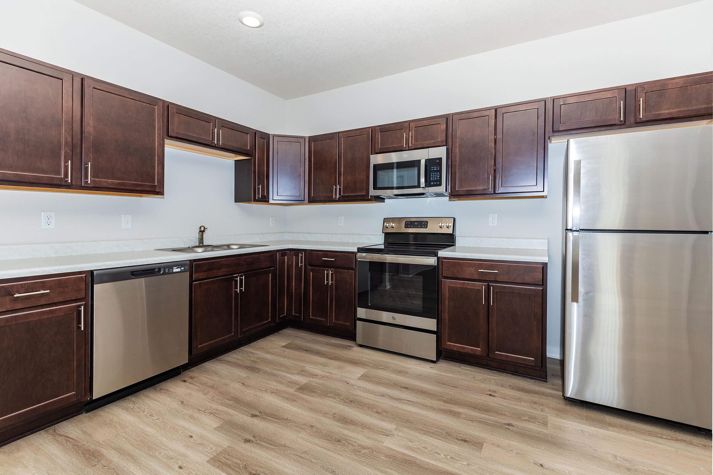 a kitchen with stainless steel appliances and wooden cabinets