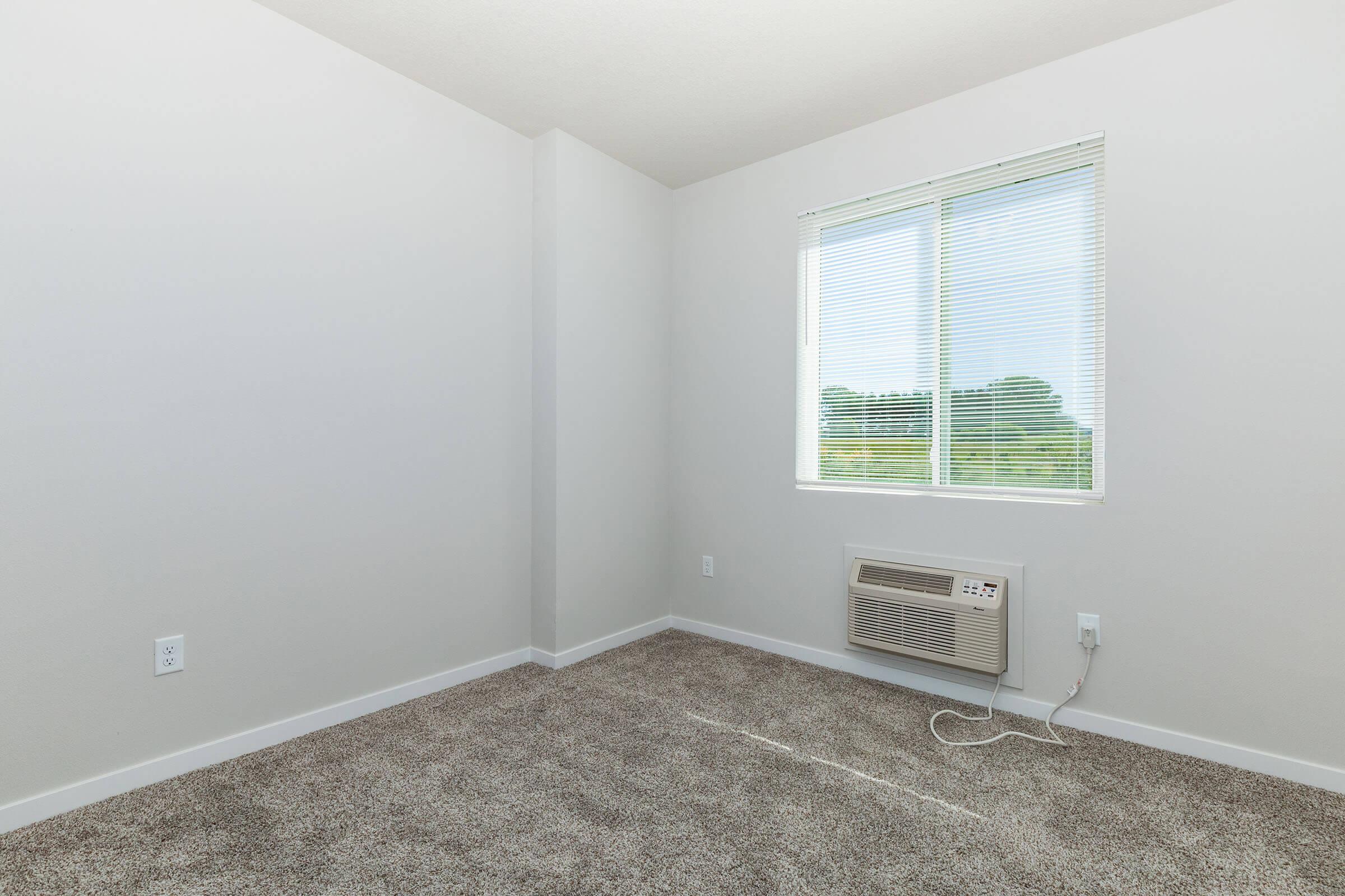 a bedroom with a large window