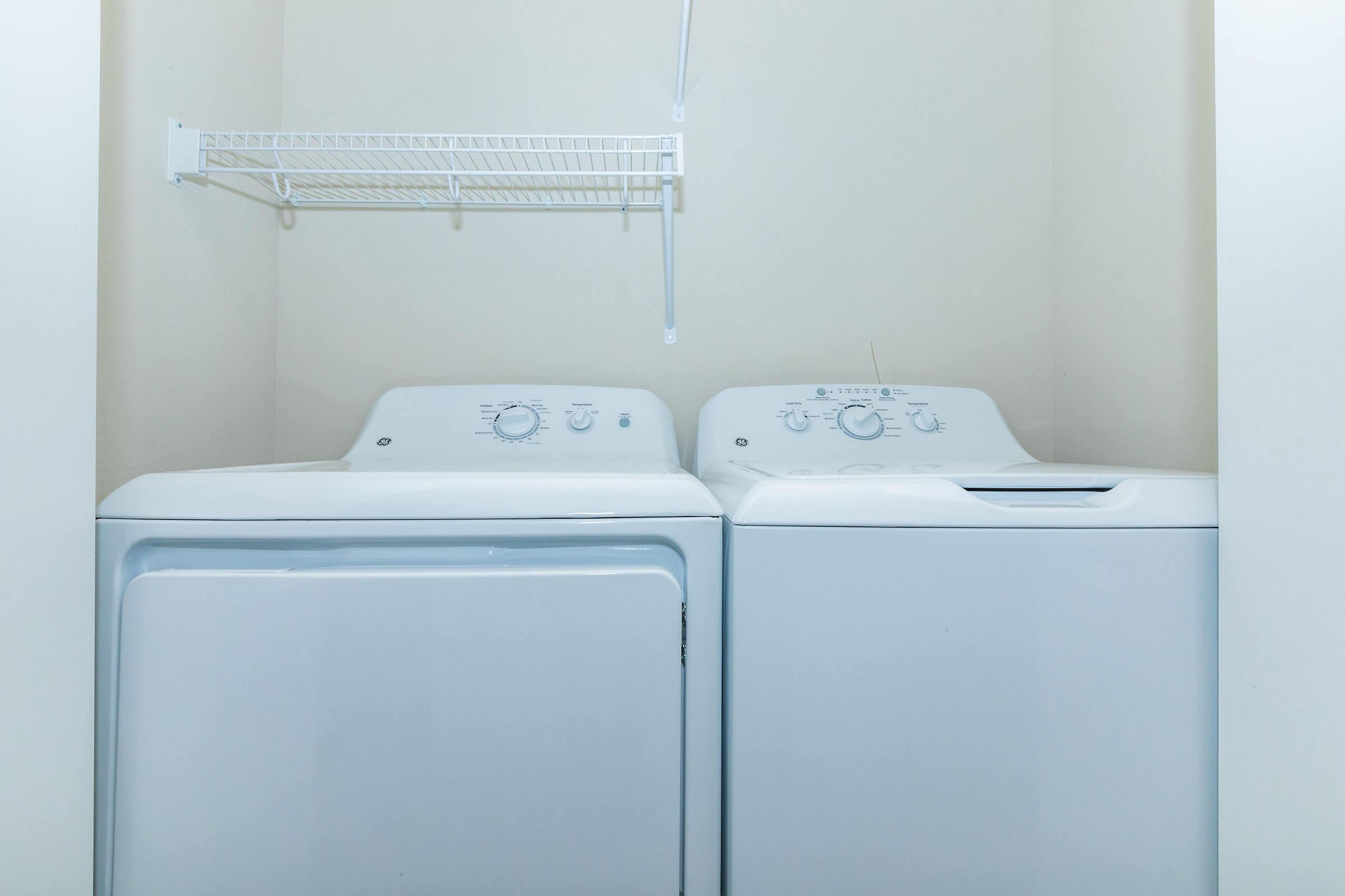 a microwave oven sitting on top of a refrigerator