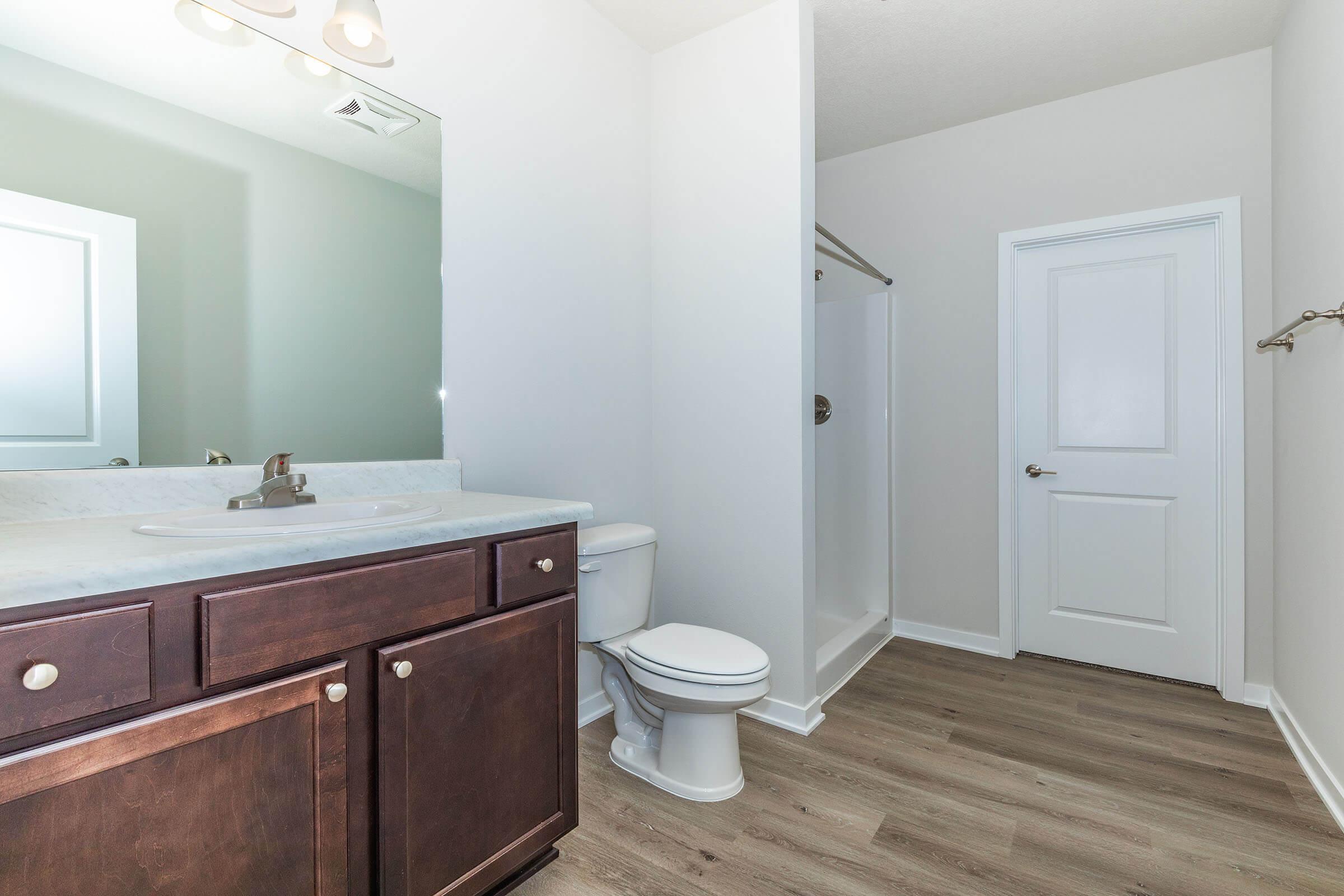 a bedroom area with a sink and a mirror