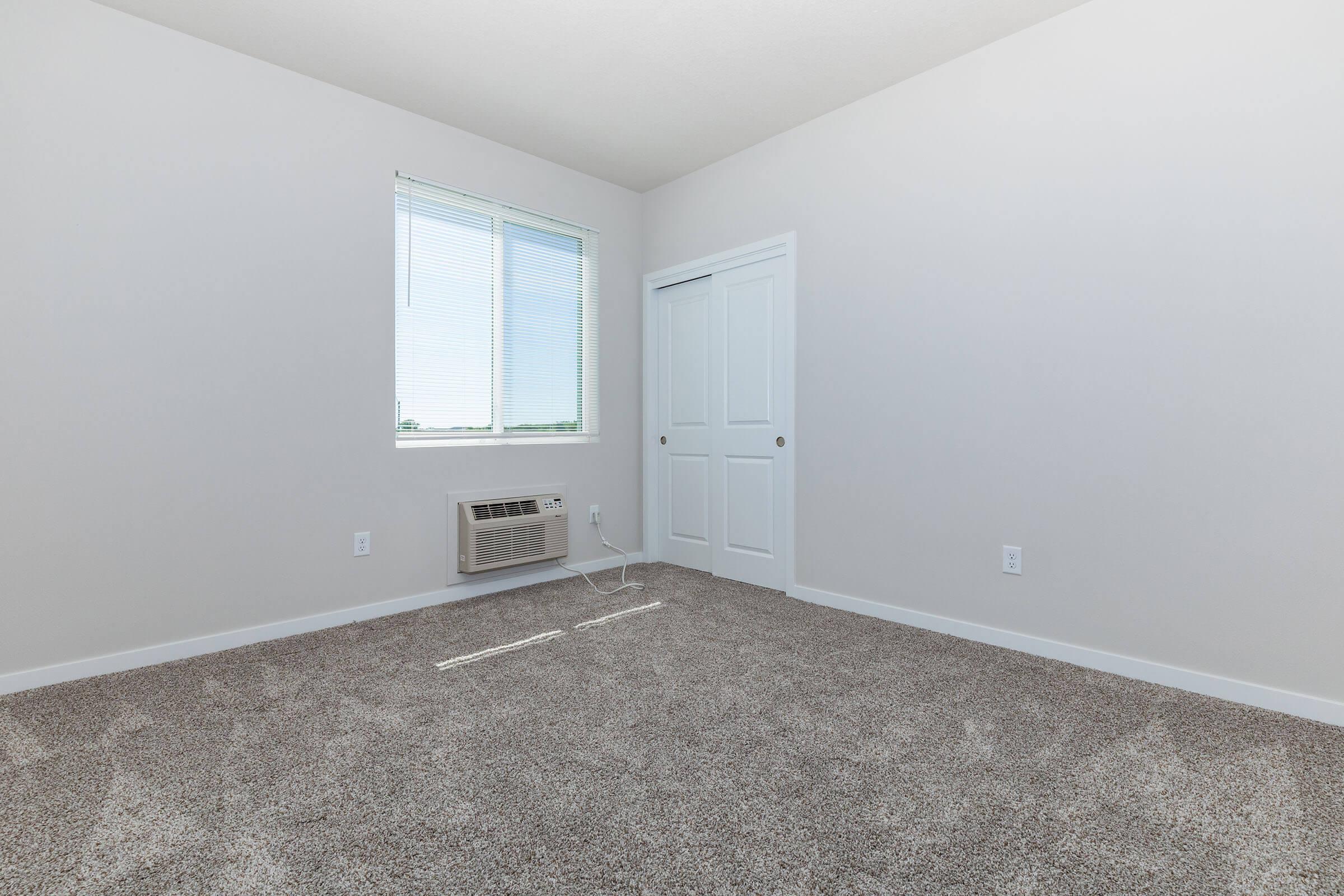 a bedroom with a large window