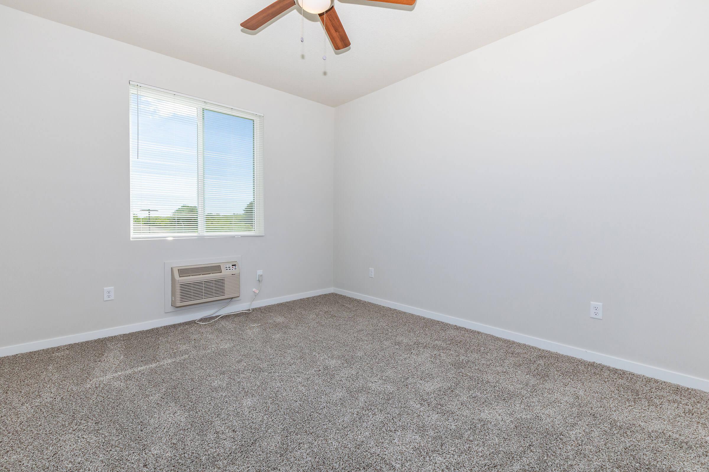 a bedroom with a large window