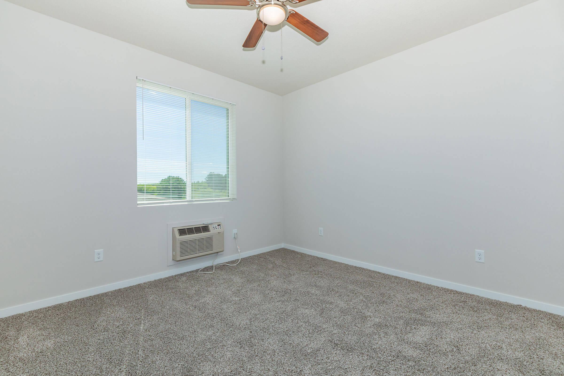 a bedroom with a large window