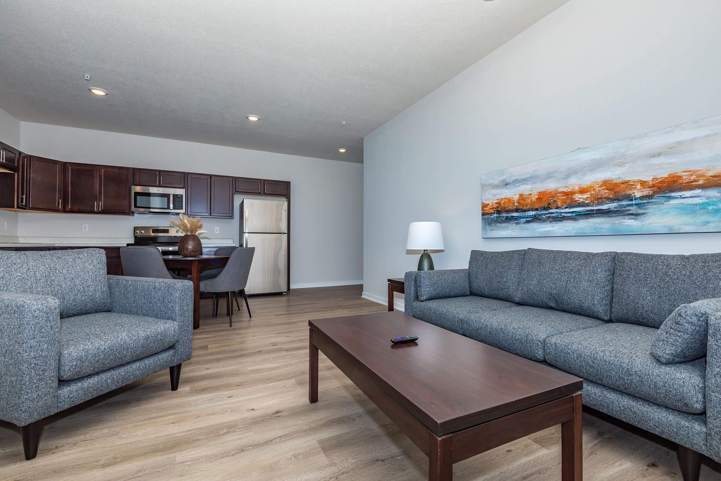 a living room filled with furniture and a flat screen tv