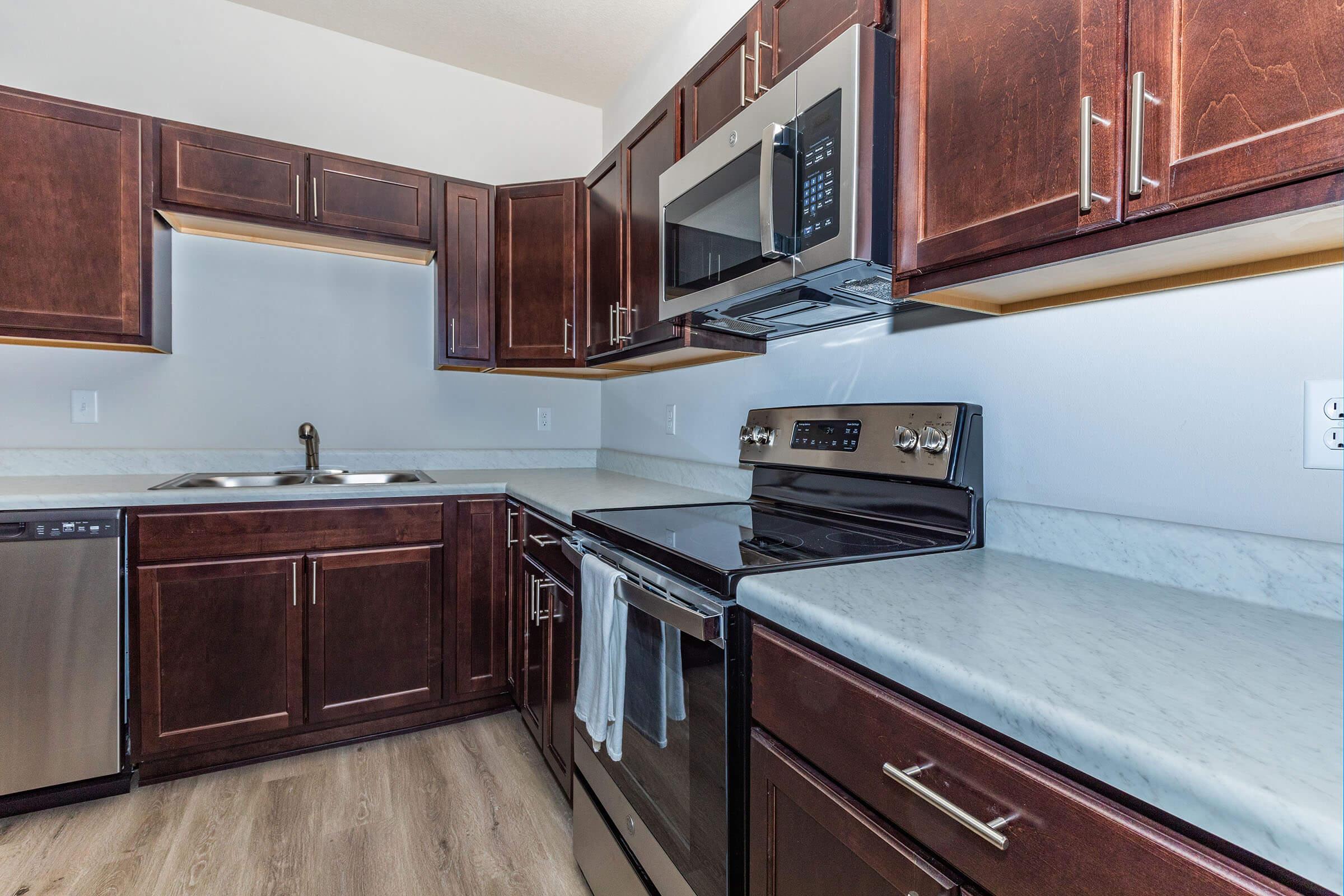 a kitchen with stainless steel appliances and wooden cabinets