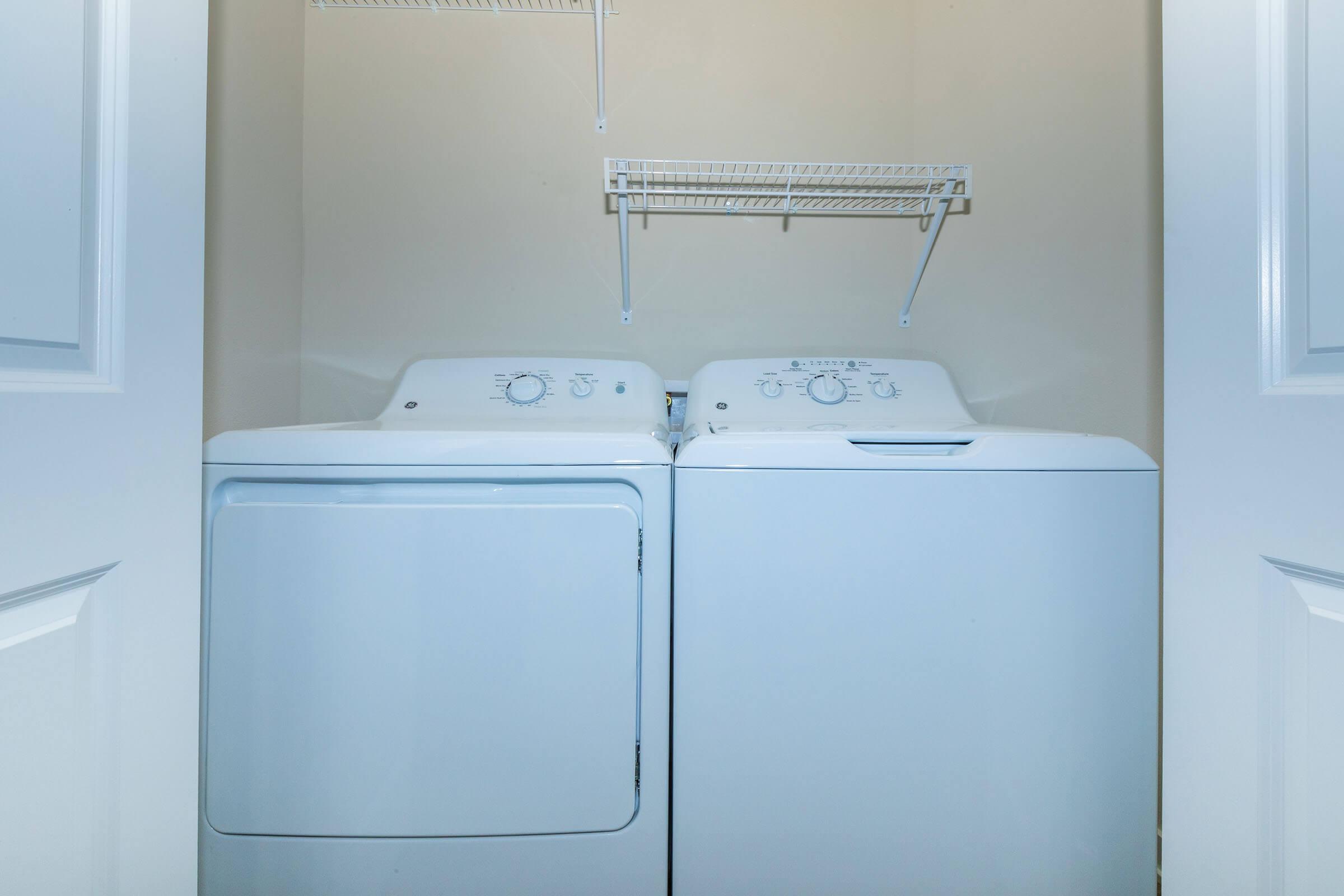 a microwave oven sitting on top of a refrigerator